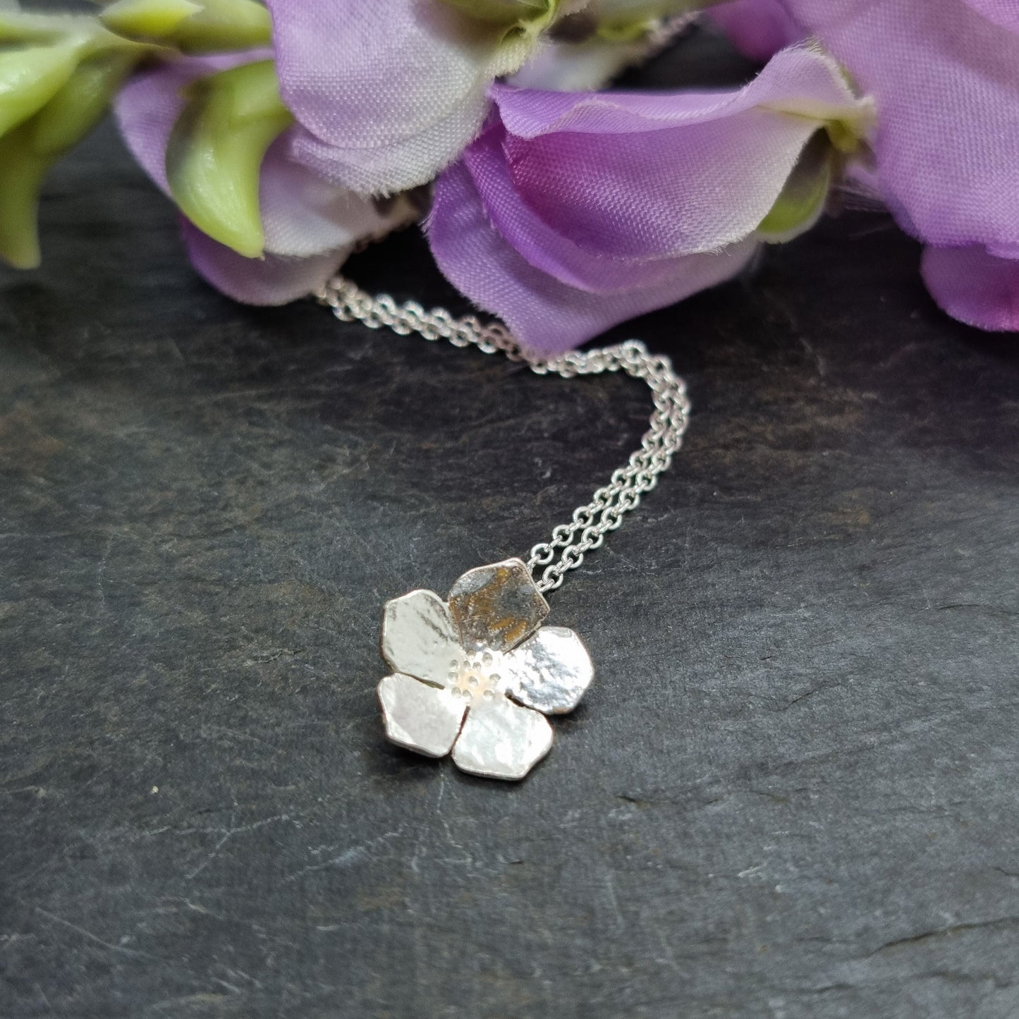 A silver 5 petal flower pendant on silver chain - small. With flowers