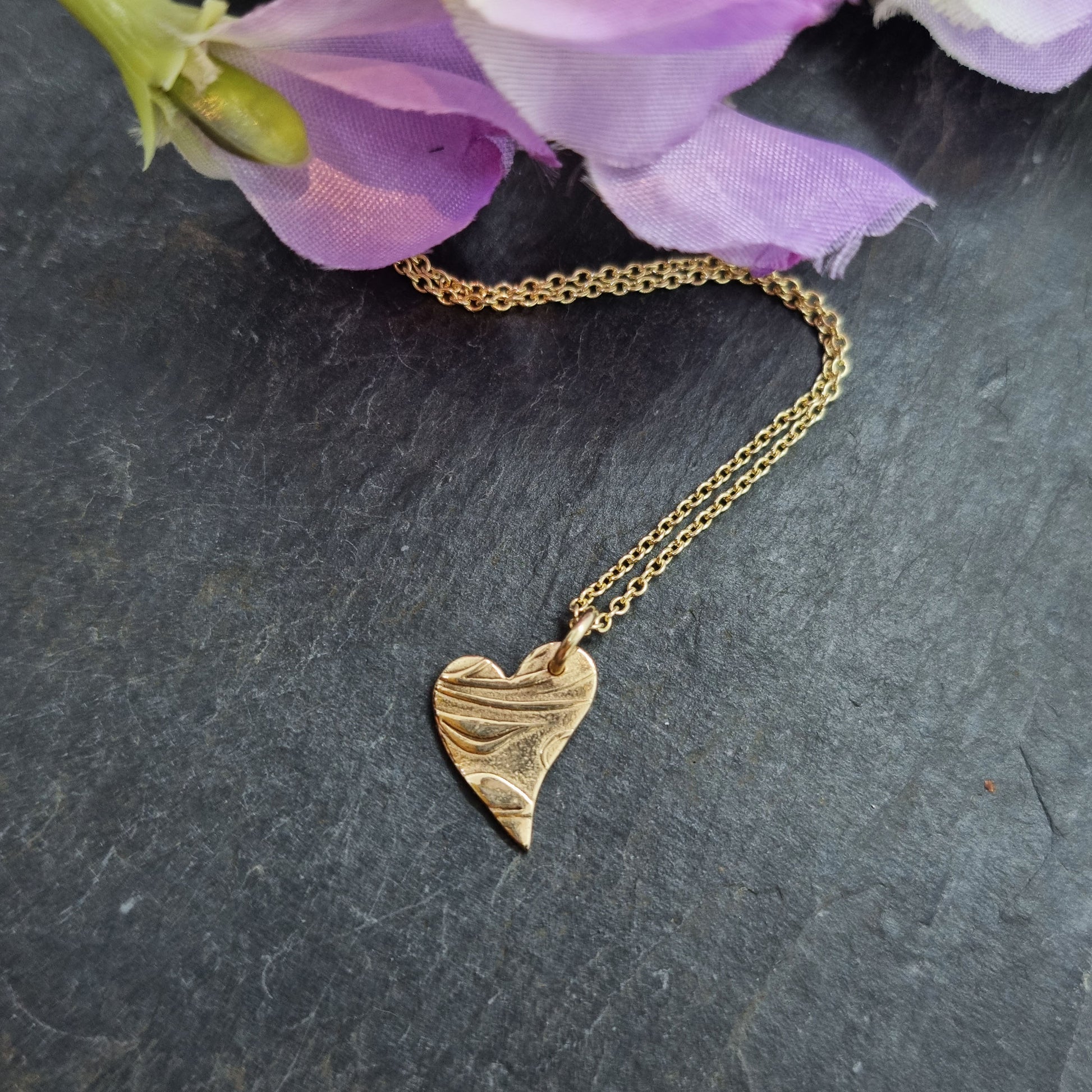 9ct yellow gold patterned asymmetrical heart pendant on chain with flowers