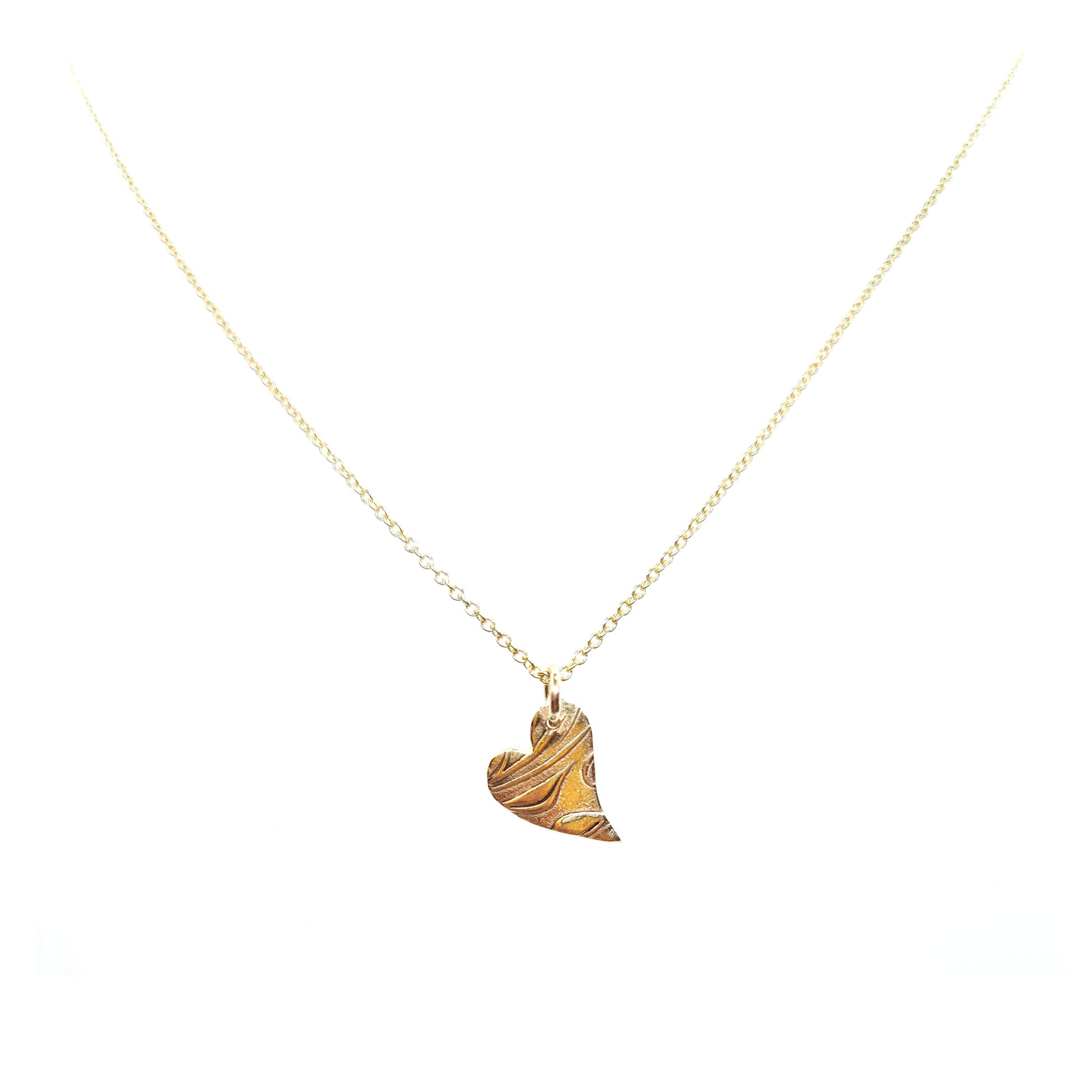 9ct yellow gold patterned asymmetrical heart pendant on chain.