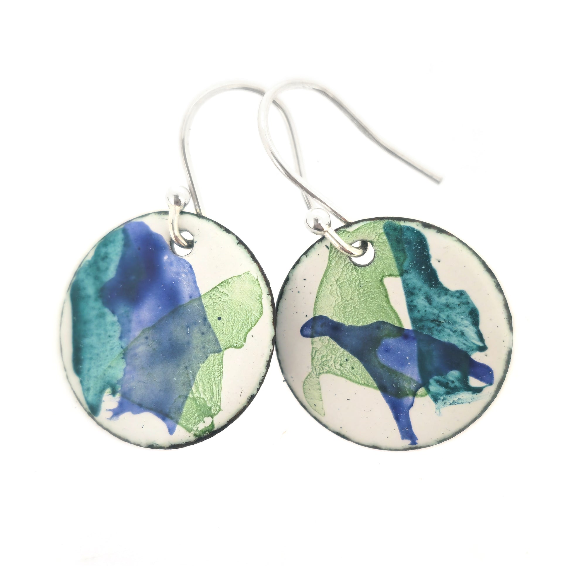 Round enamel drop earrings with splashes of dark blue and green on a white background. Small