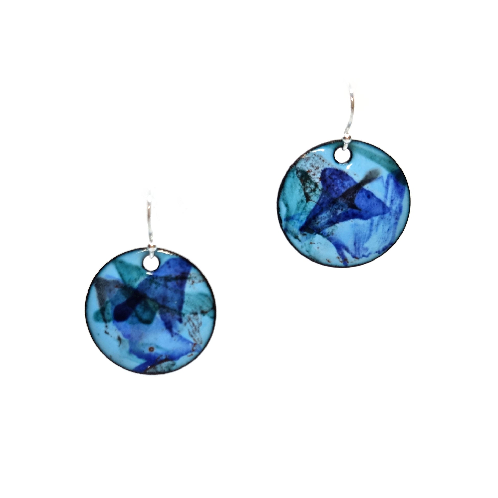 Round enamel drop earrings with splashes of dark blue, grey and red on a light blue background.