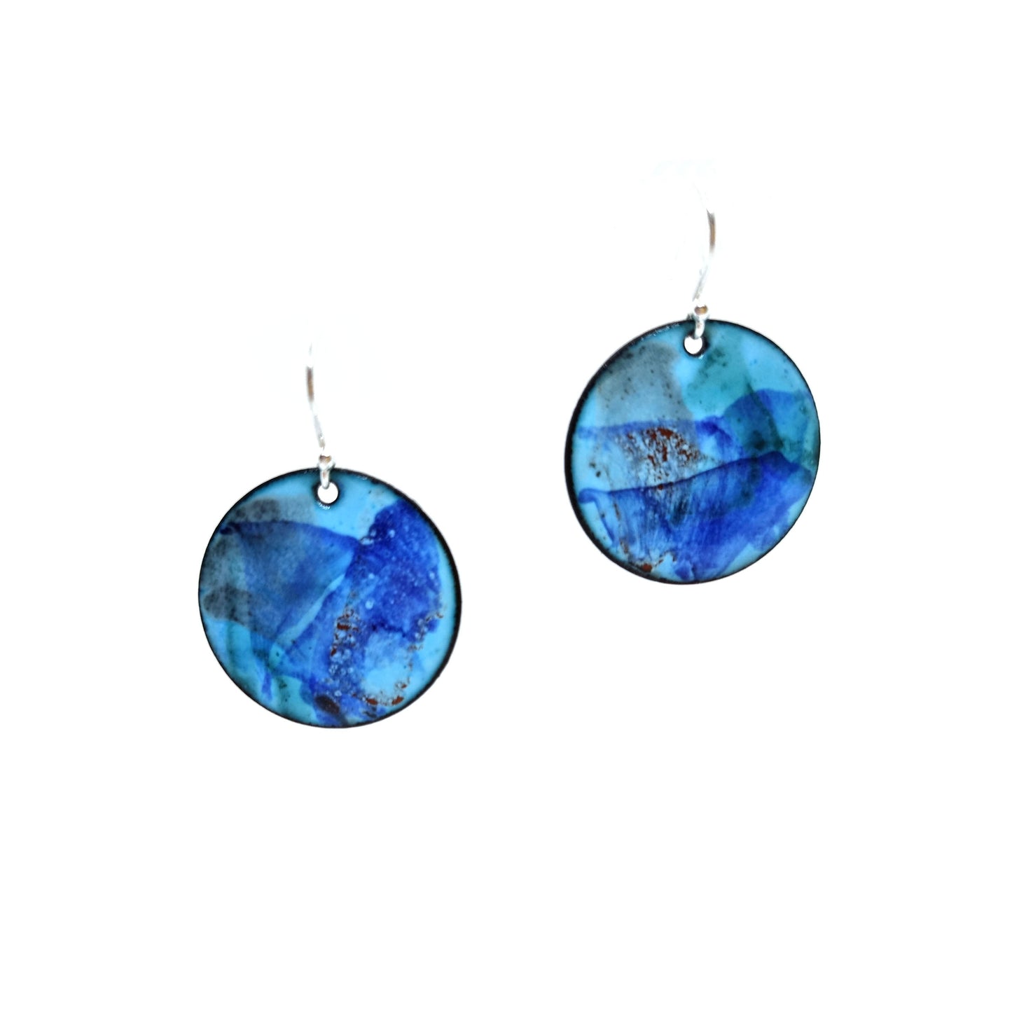 Round enamel drop earrings with splashes of dark blue, grey and red on a light blue background.