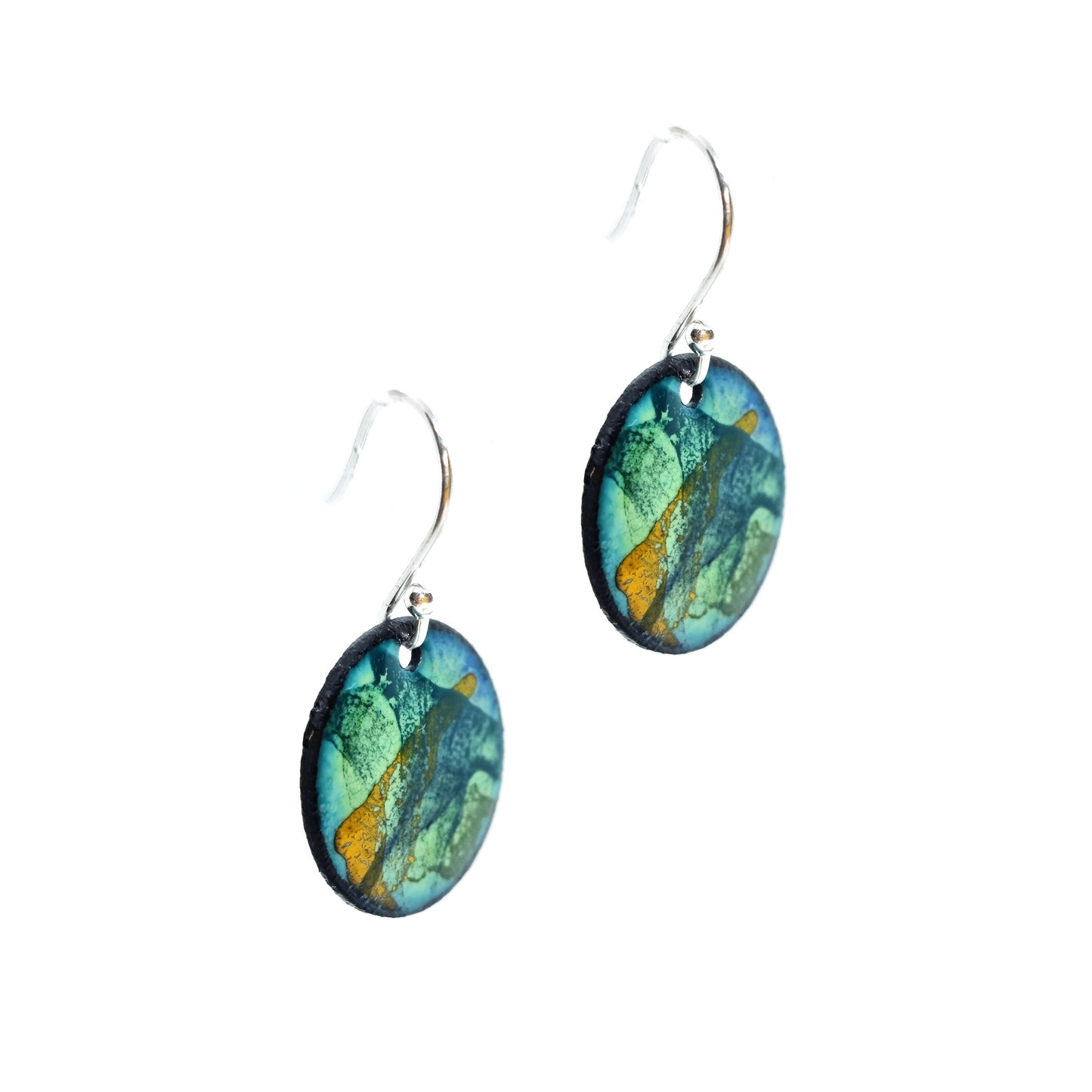 Round enamel drop earrings with splashes of blue, green and yellow on a light green background
