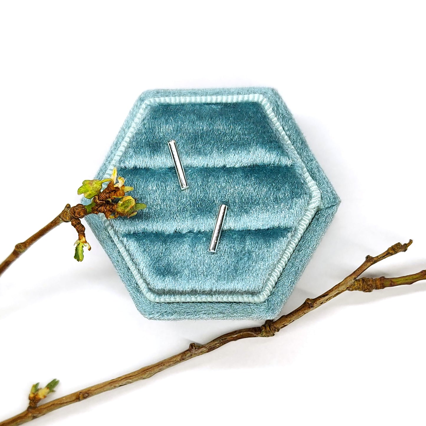 Silver bar stud earrings in jewellery box with twig