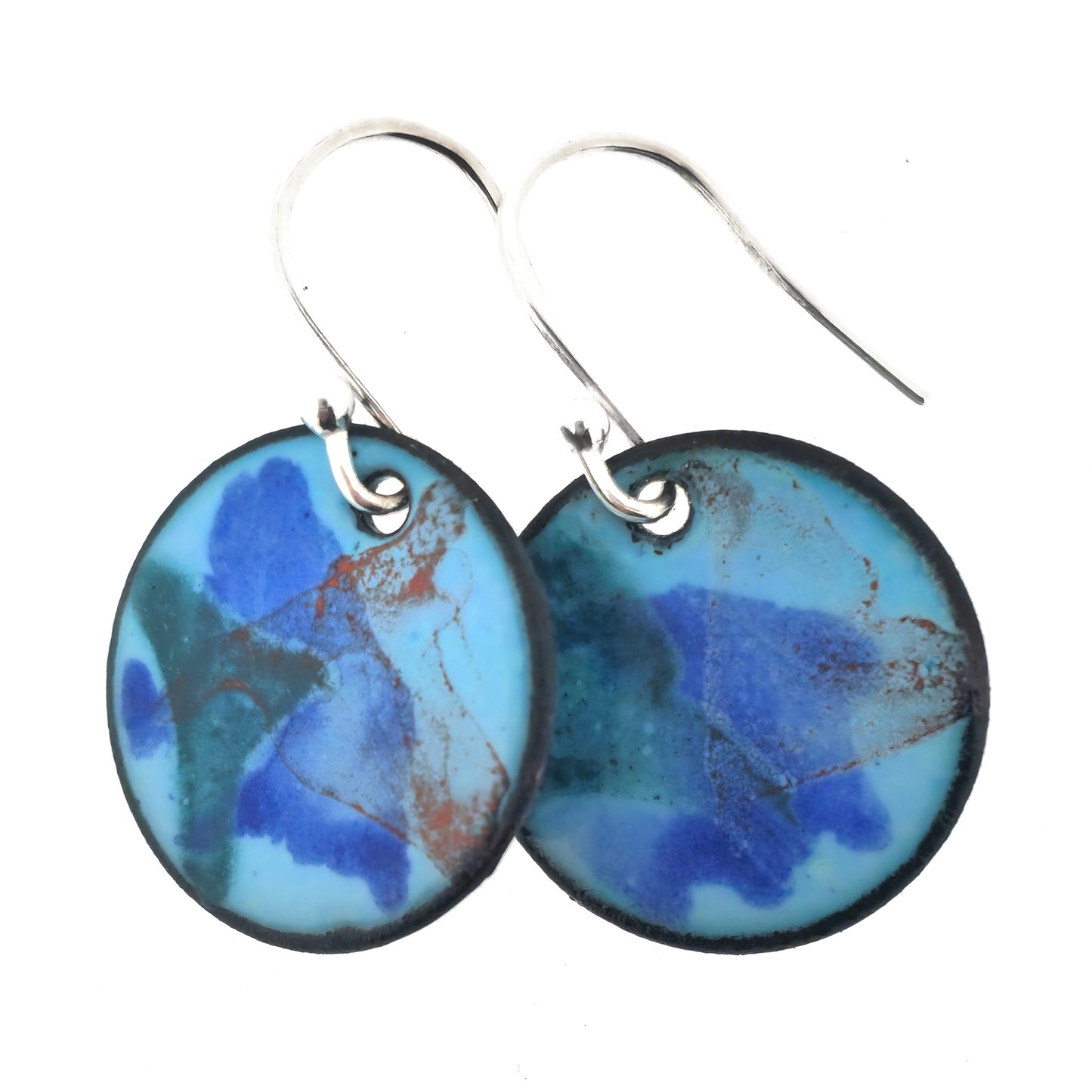 Round enamel drop earrings with splashes of dark blue, grey and red on a light blue background.