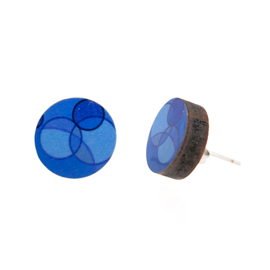 Round stud earrings made of wood with a blue circle retro-style pattern.