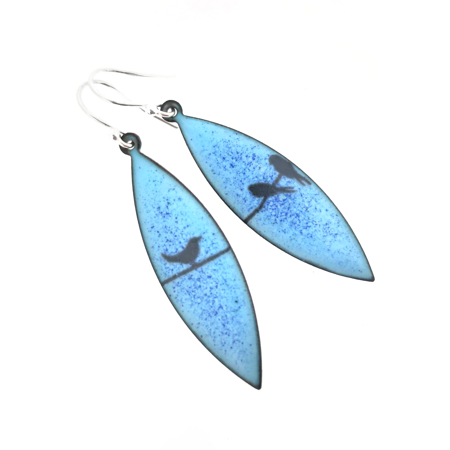 Boat-shaped enamel drop earrings with black coloured bird silhouettes sitting on a wire on a blue background