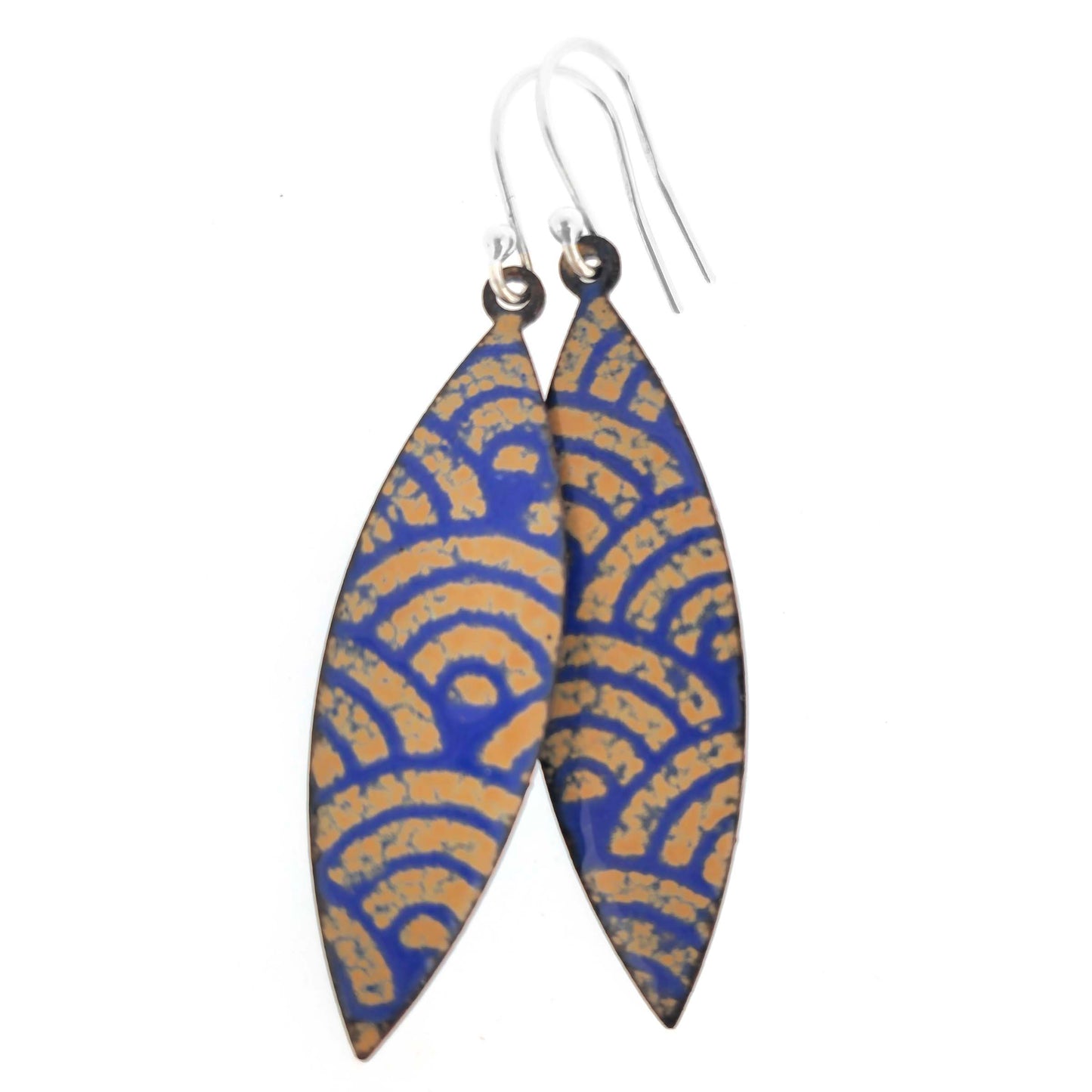 Pair of blue and gold enamel patterned earrings with silver ear hooks on a white background
