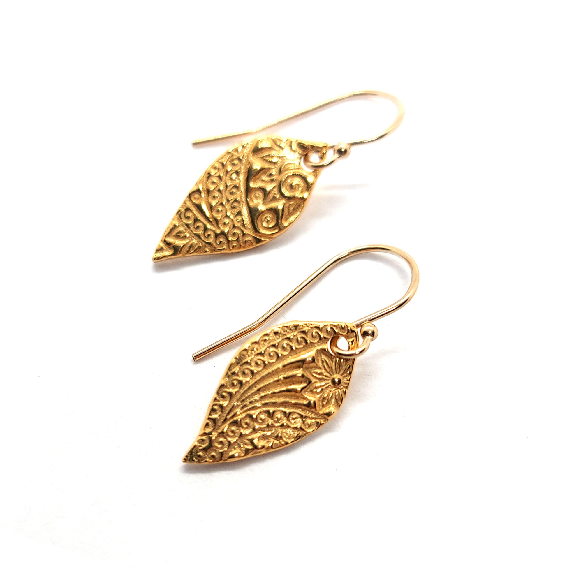 Yellow gold vermeil leaf-shaped patterned drop earrings.