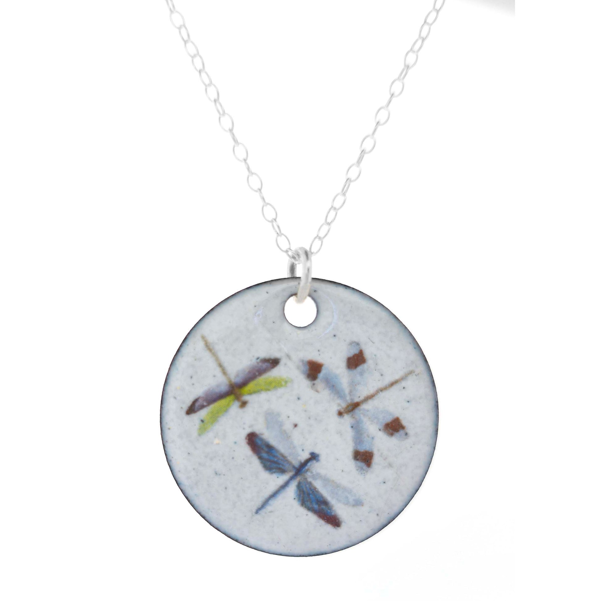 Necklace with a round enamel pendant featuring three dragonfly designs on a silver chain on a white background.