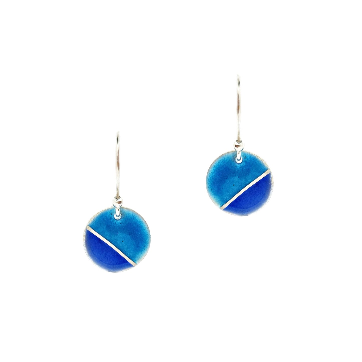 Silver round drop earrings with blue enamels. A silver line runs at an angle across the circle with light turquoise blue in the top part and dark royal blue in the bottom part.