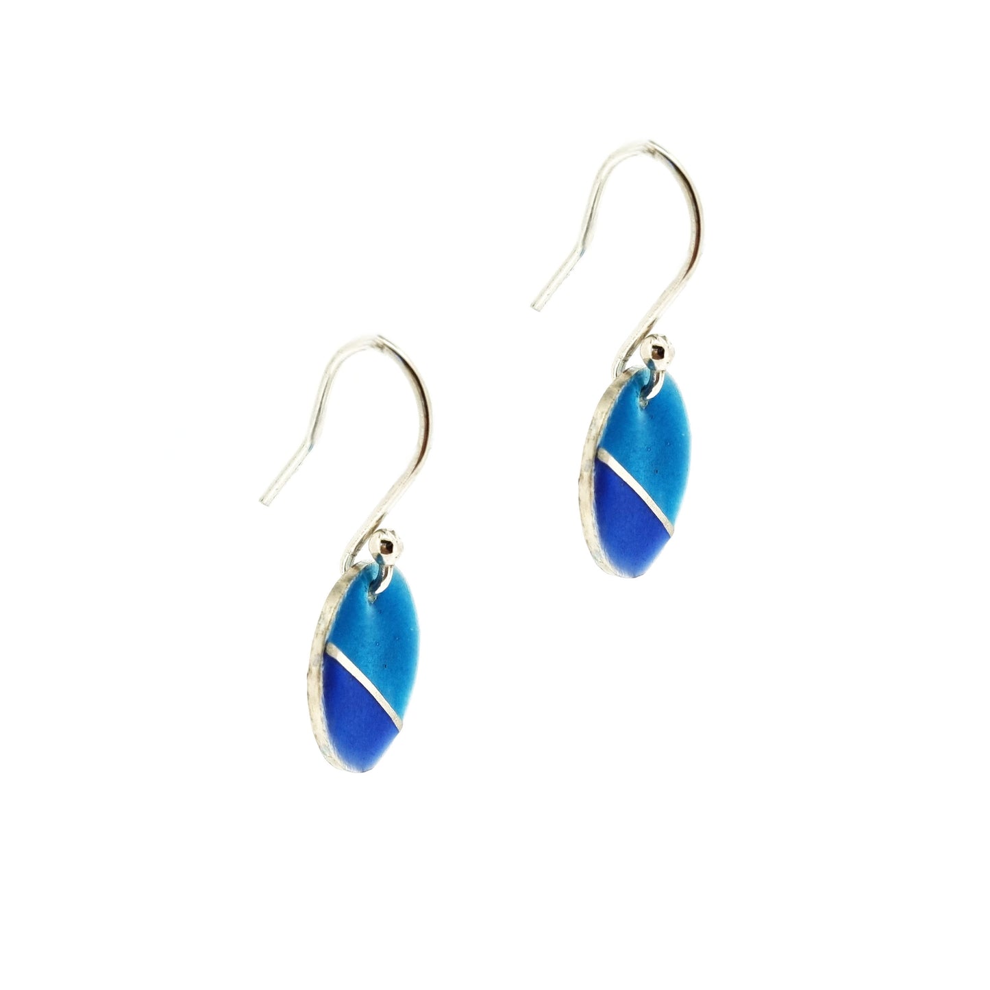 Silver round drop earrings with blue enamels. A silver line runs at an angle across the circle with light turquoise blue in the top part and dark royal blue in the bottom part. Side view.
