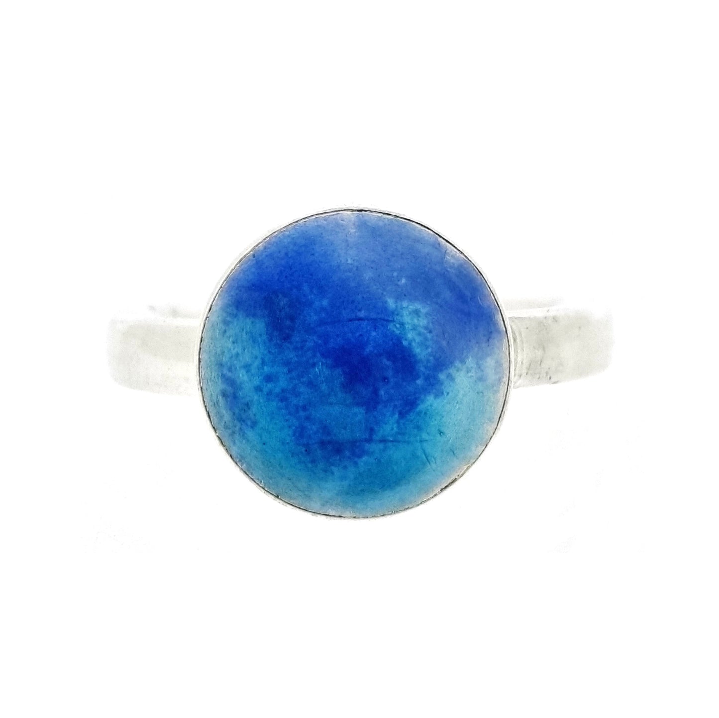 A silver ring band with a round silver top coloured with dark blue and turquoise blue enamel.