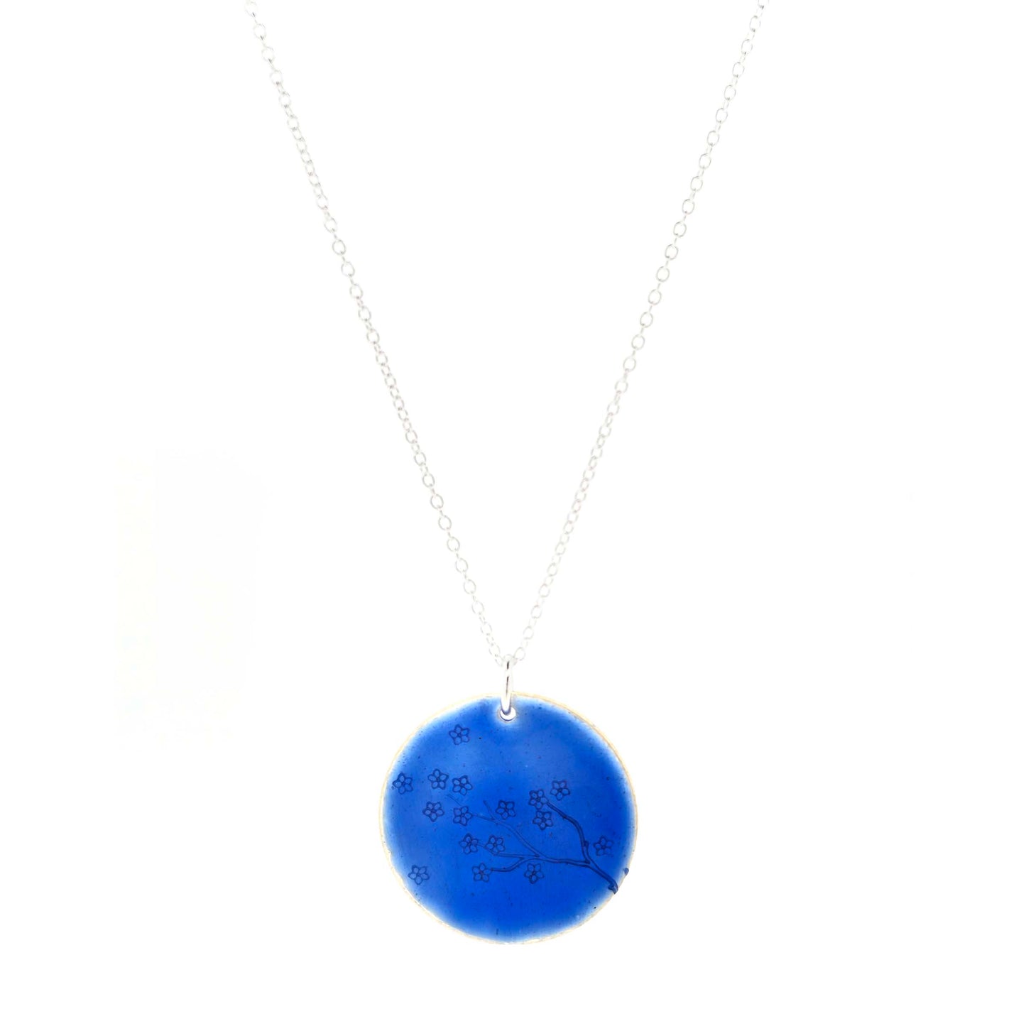 Silver and blue enamel pendant necklace with a flower branch design on a white background.