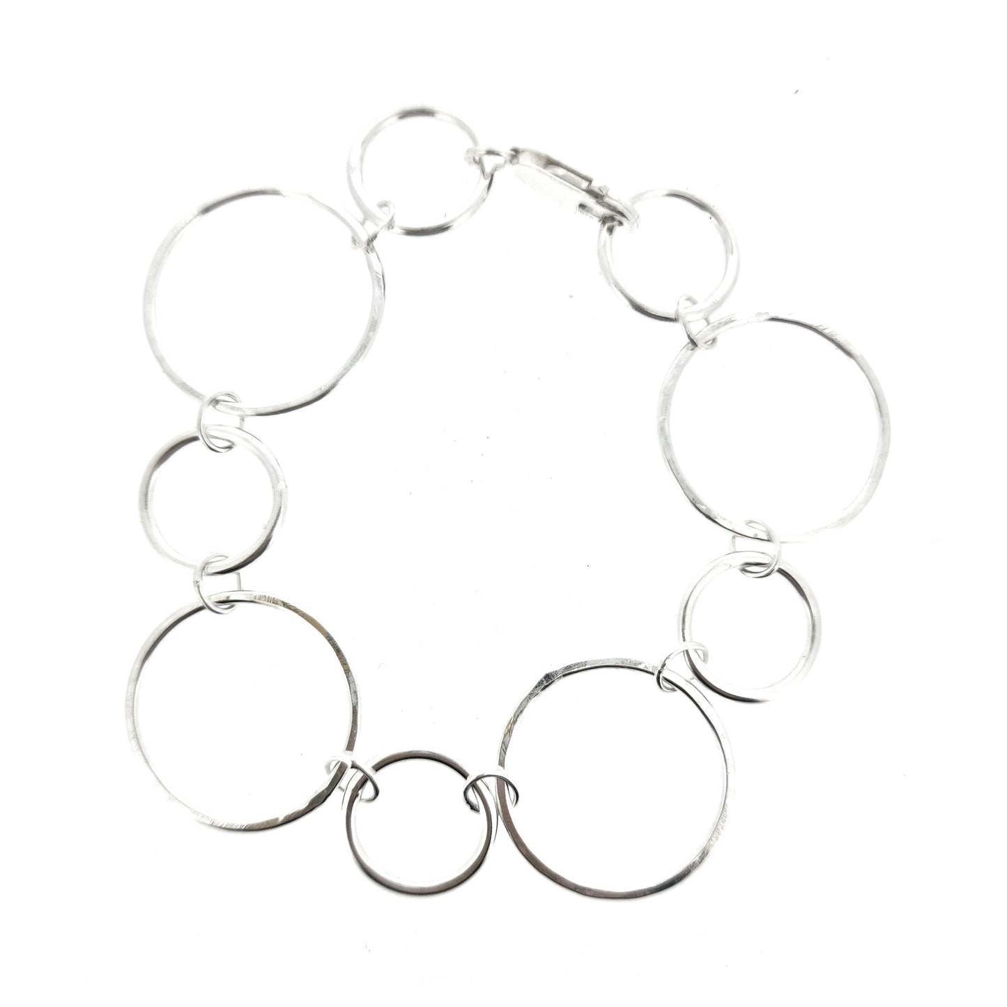 Silver chain link bracelet with 2 sizes of circles, one size has a hammered finish