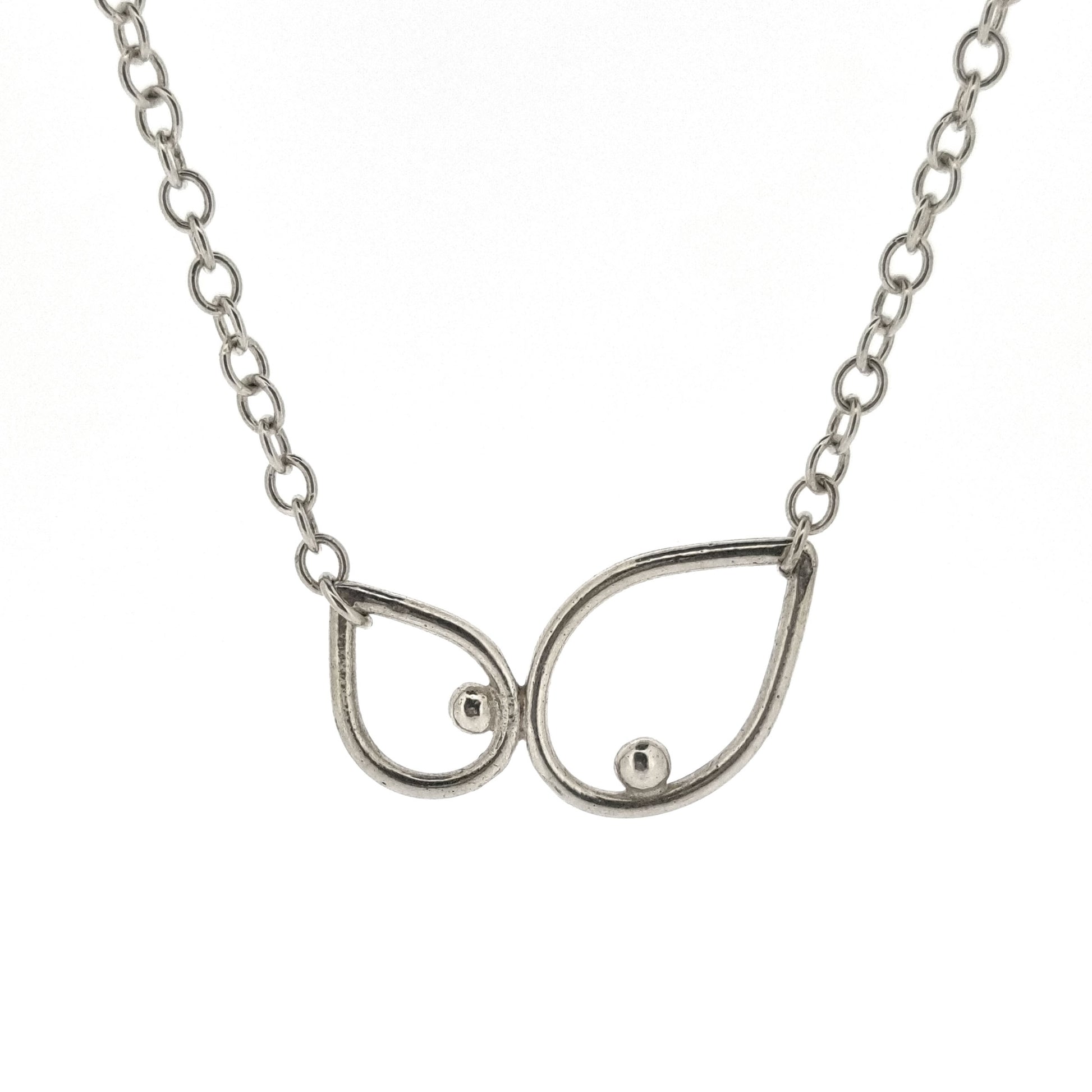 A silver chain necklace with 2 open teardrop shapes at the centre. Each teardrop has an off-centre ball.
