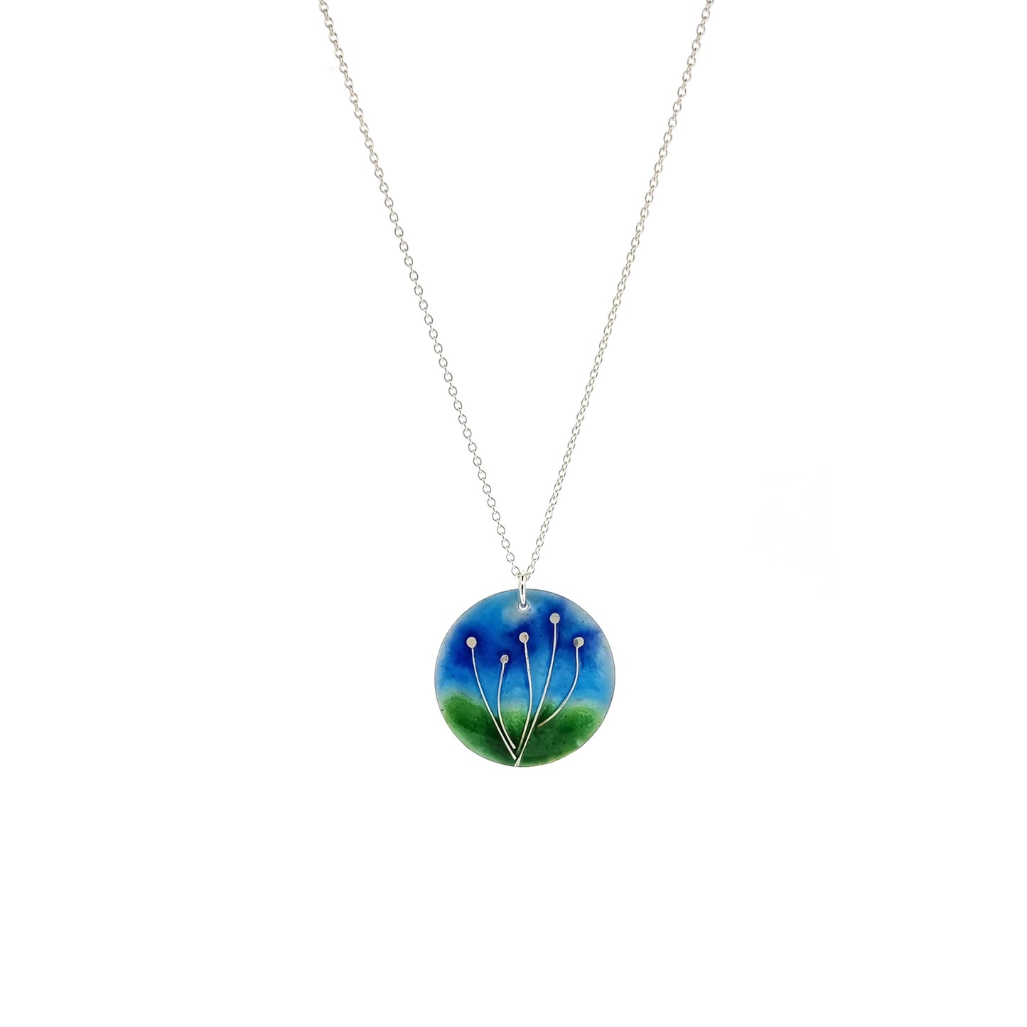 Round silver pendant with silver flowers and blue & green enamels. On silver chain.
