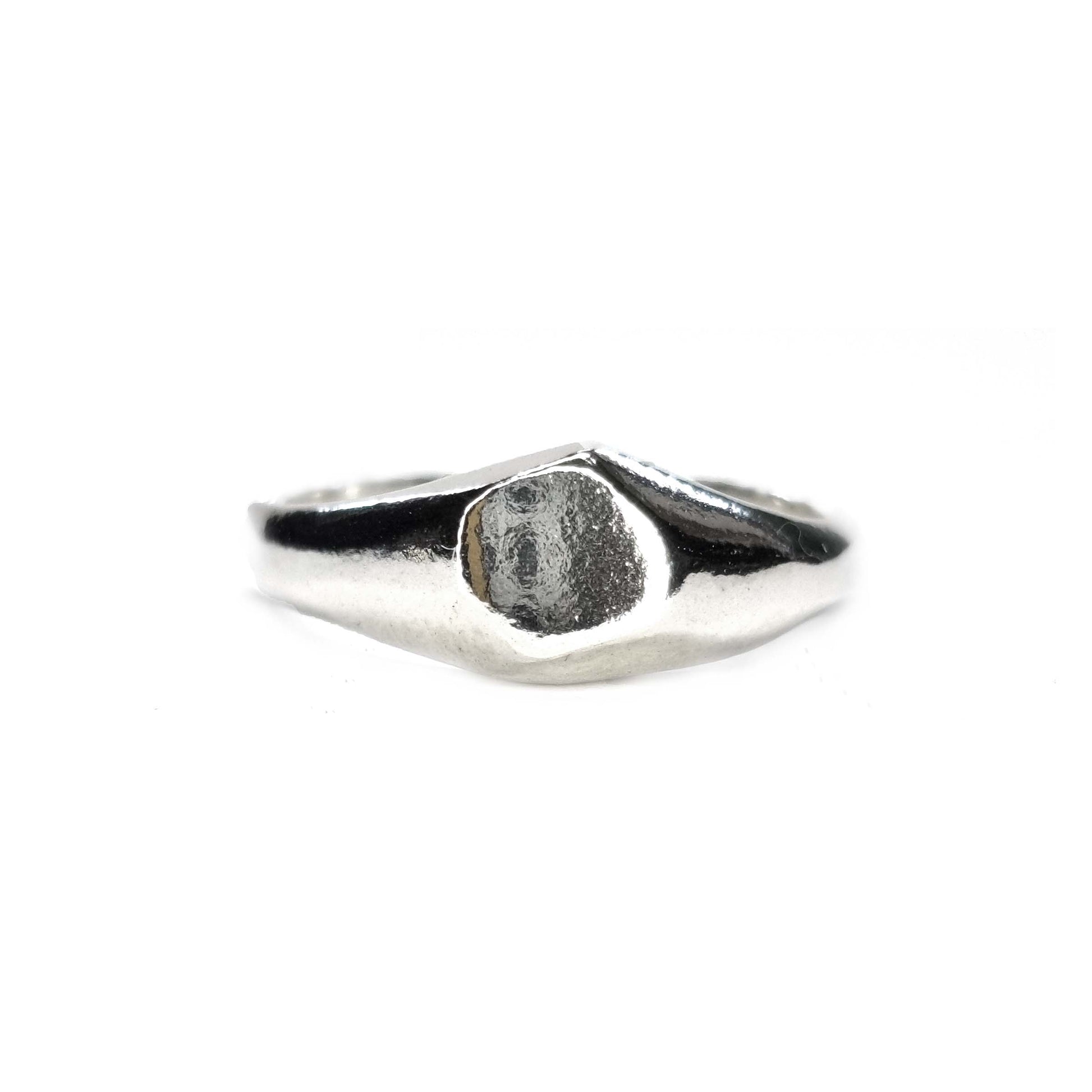 A silver geometric signet ring with flat head.