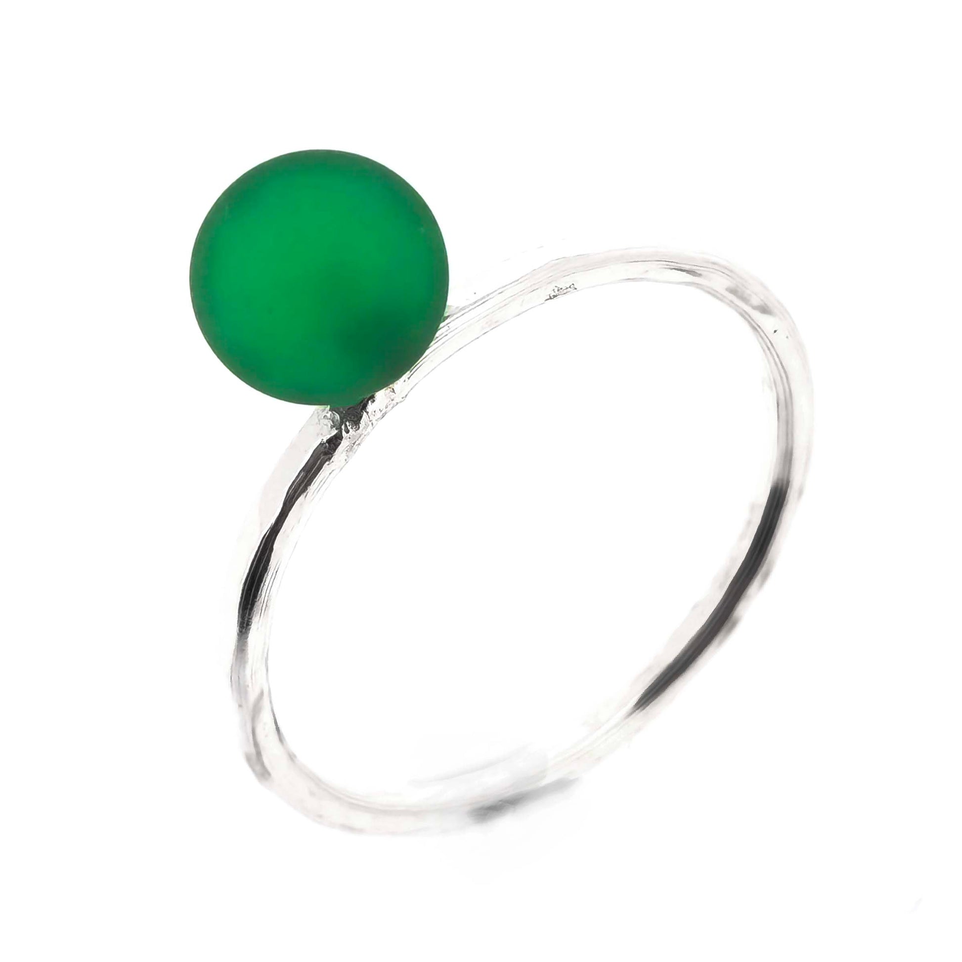 A ring with a thin silver band with a hammered finish and a green glass sphere on top. Mijoux Creations.