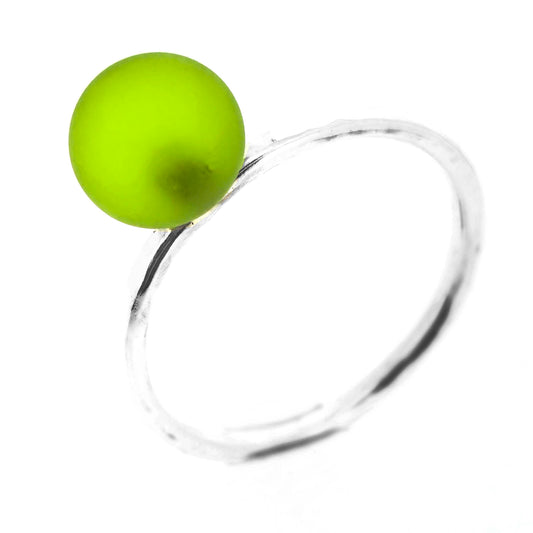 A silver stacking ring with a thin silver band with a hammered finish and a light green glass sphere at the top.