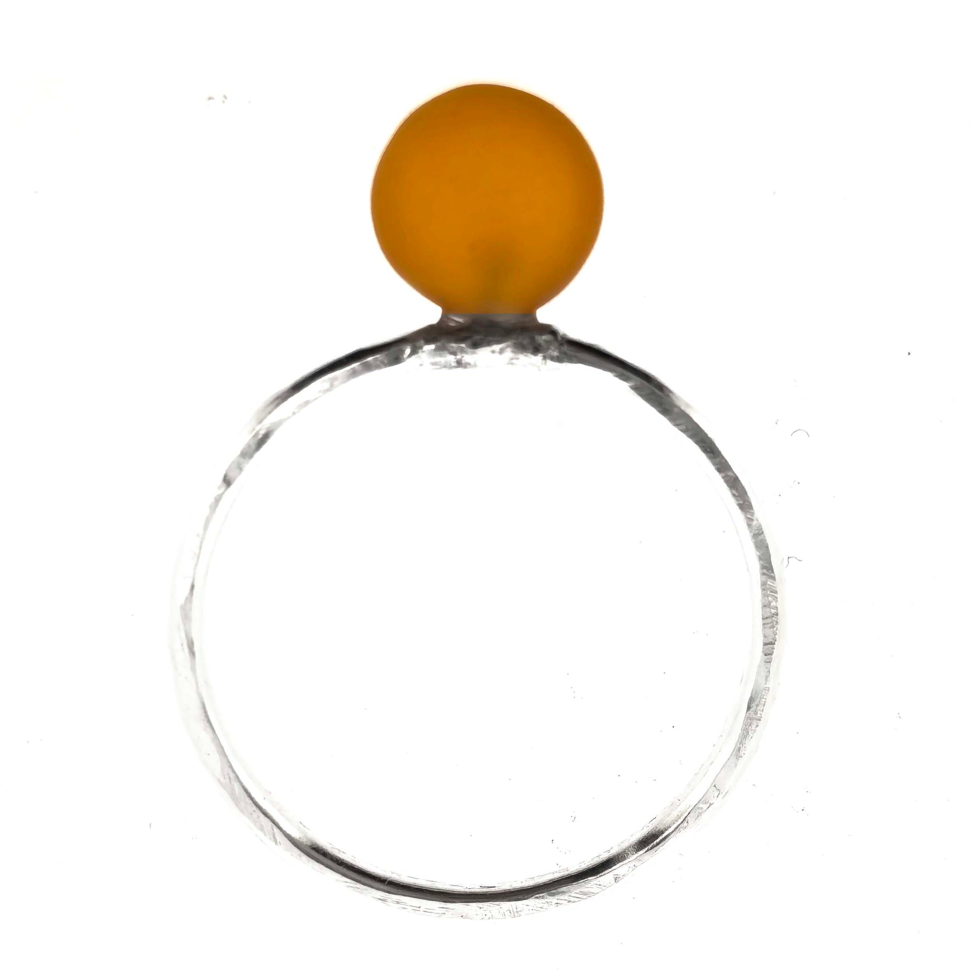 A silver ring with a thin band with a hammered finish and an orange glass sphere on top. Mijoux Creations.