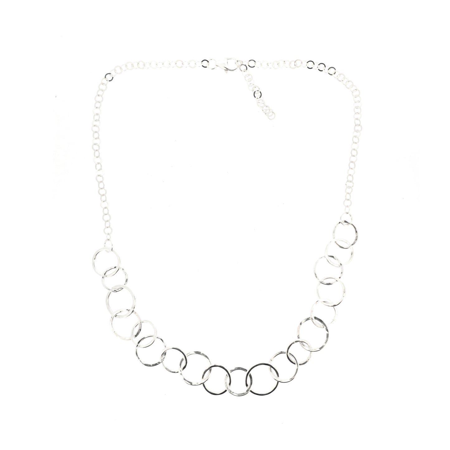 A silver necklace made up of different size circles with a hammered finish and smaller silver chain at the back.