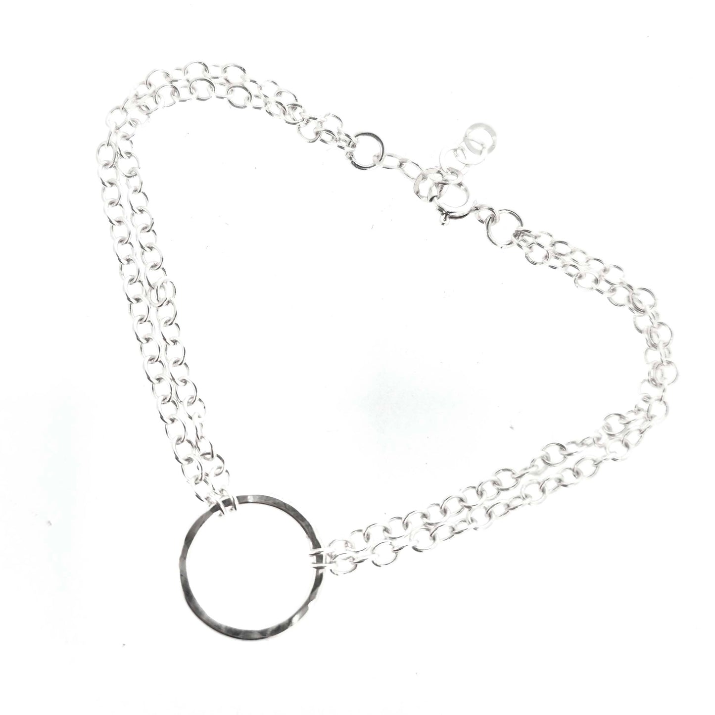 Silver double chain bracelet with a central hammered circle on a white background