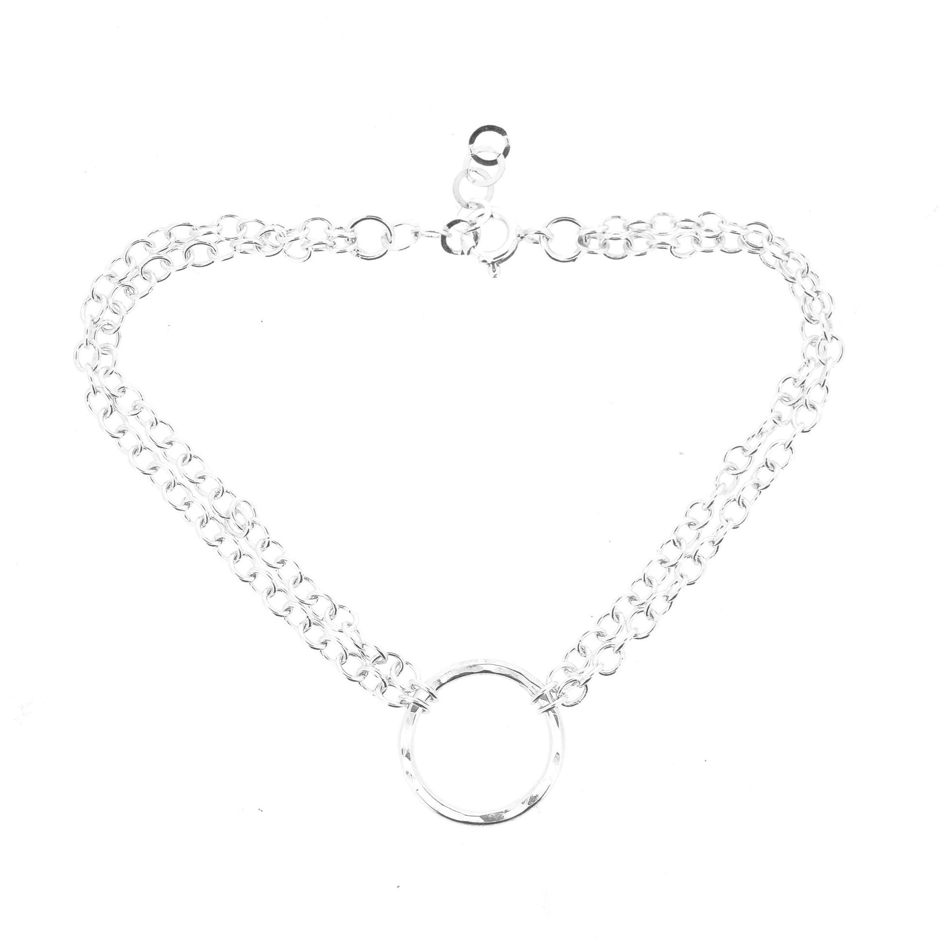 Silver double chain bracelet with a central hammered circle on a white background