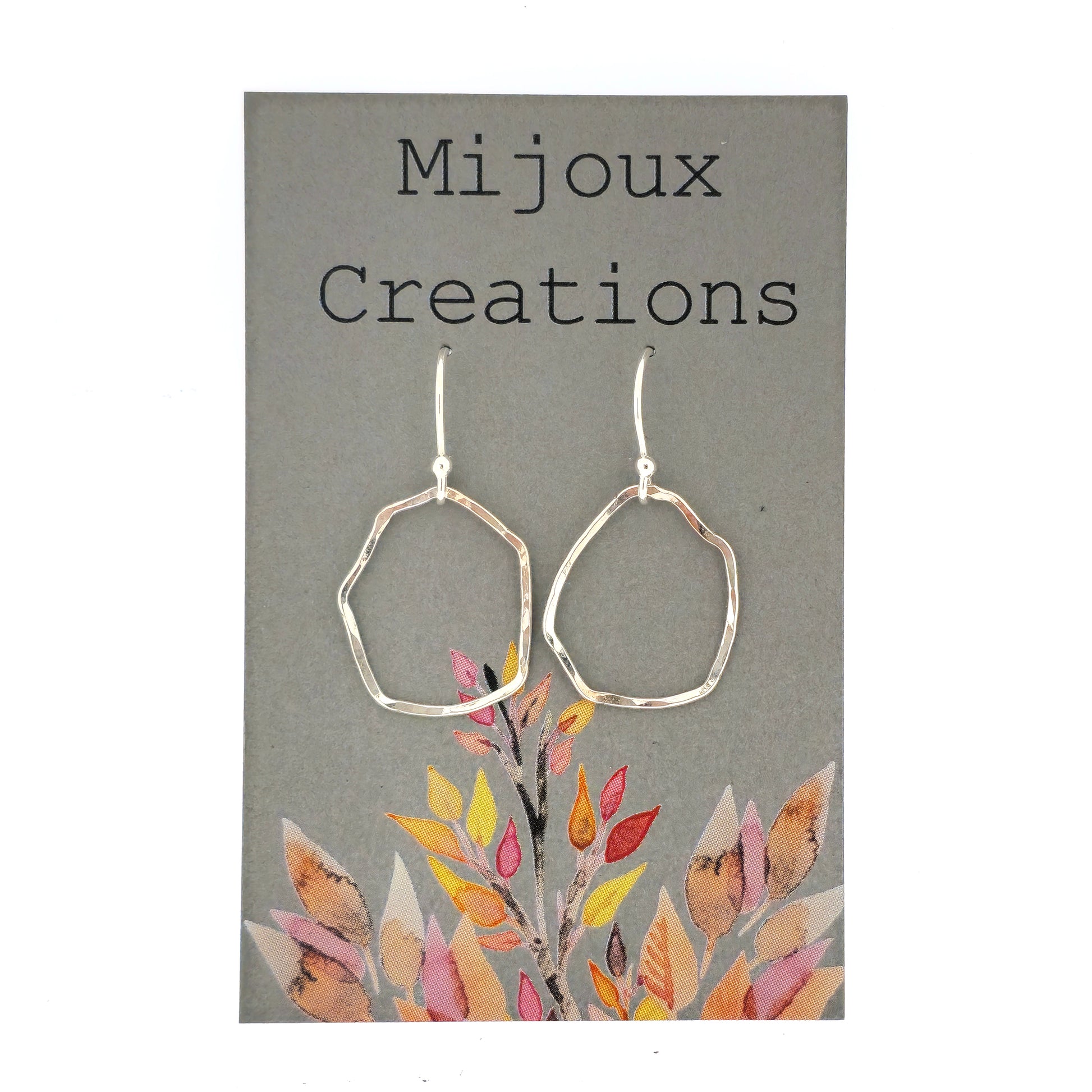 Silver drop earrings with an open organic rustic style circle suspended from silver ear wires - large. Shown on a Mijoux card.
