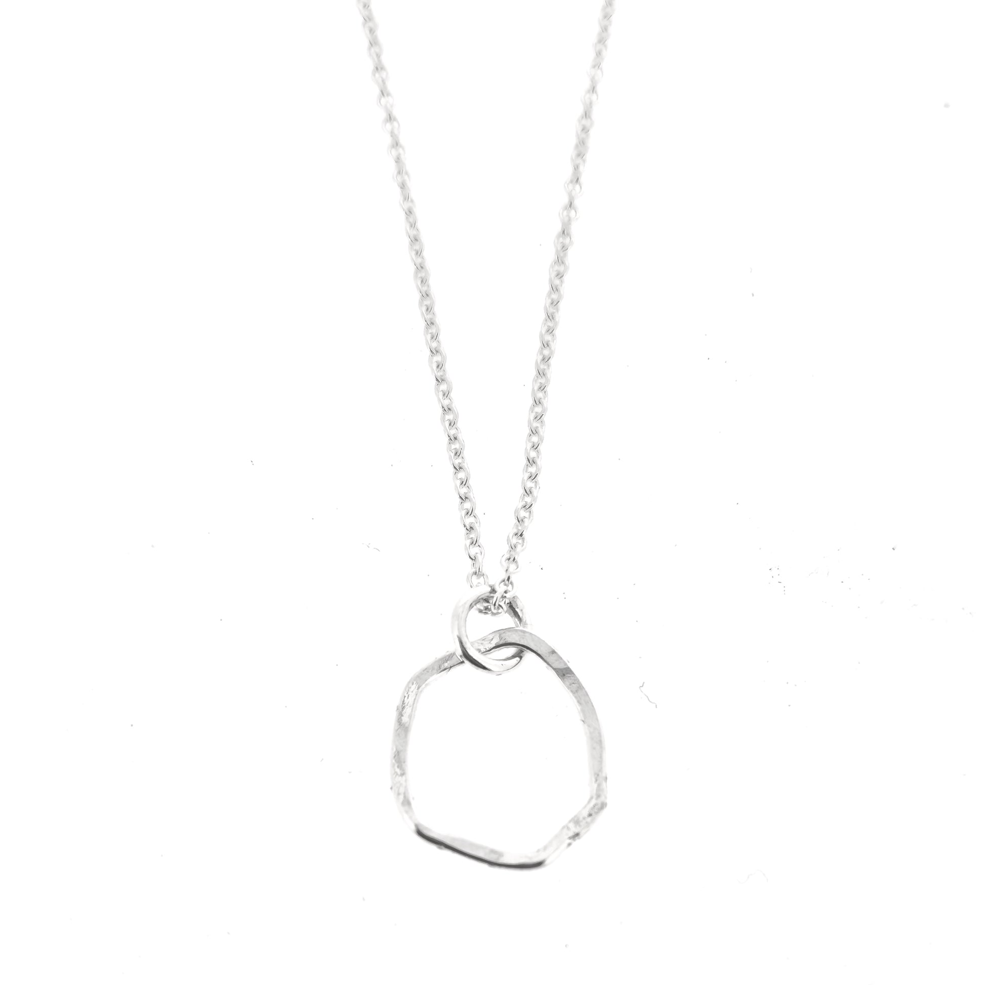 A silver pendant necklace consisting of an open organic rustic style silver circle with a hammered finish suspended from a silver chain - small.