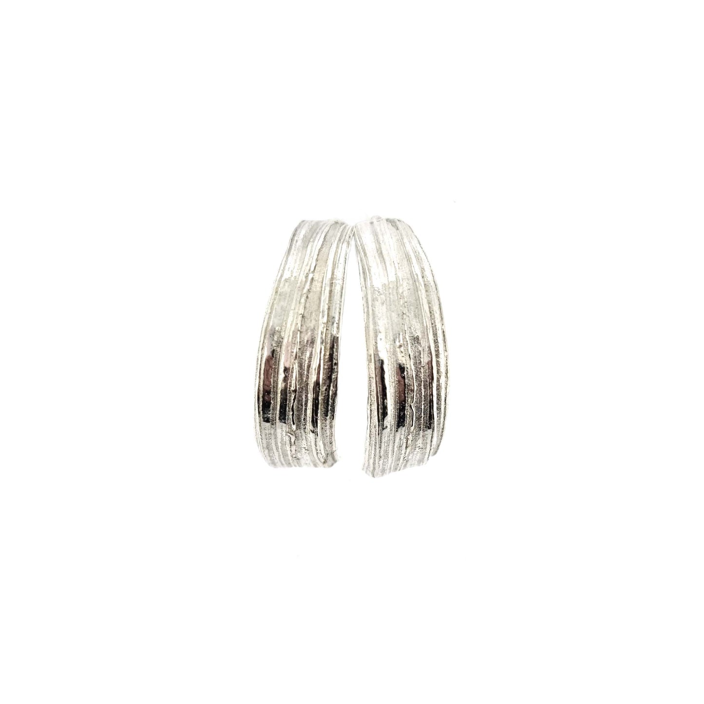 Silver bark textured half hoop earrings.