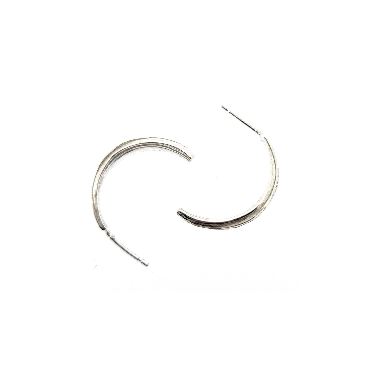 Silver line textured half hoop earrings.