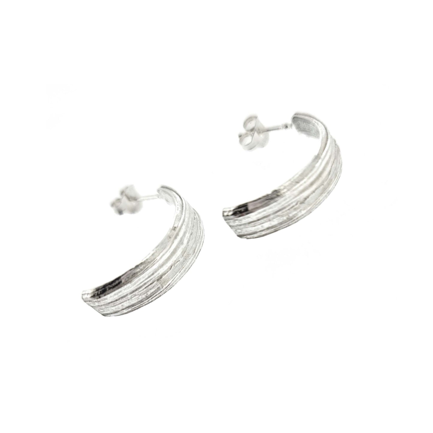 Silver line textured half hoop earrings.