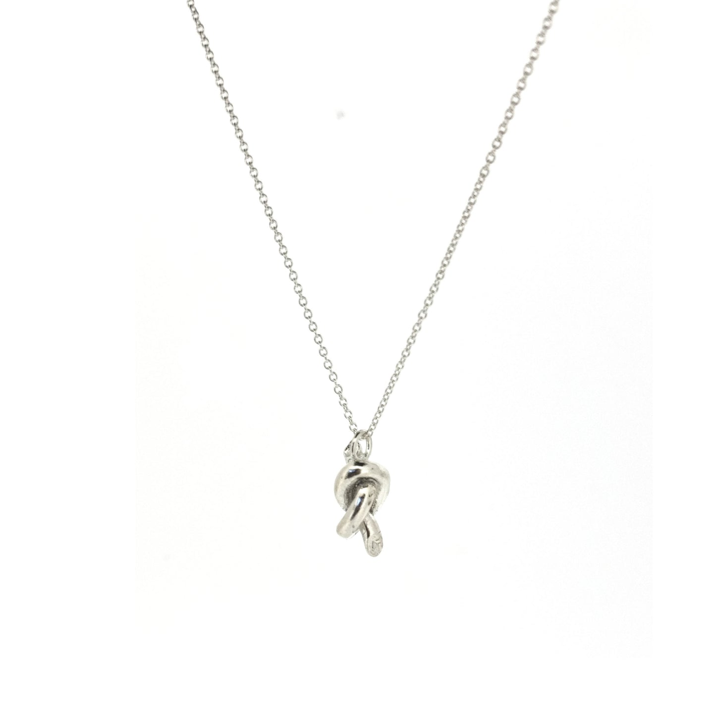 Silver chain with a silver knot pendant.