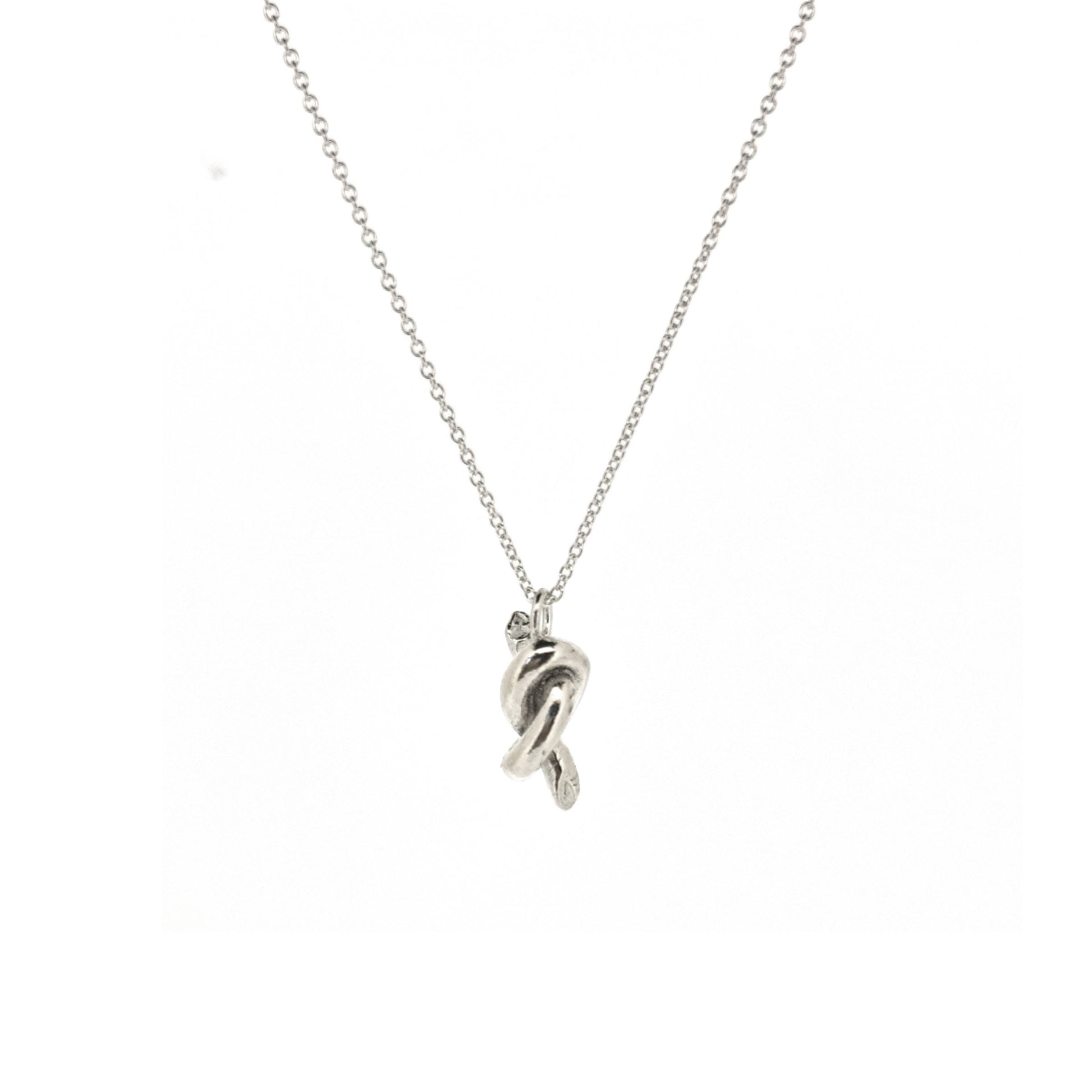 Silver chain with a silver knot pendant.