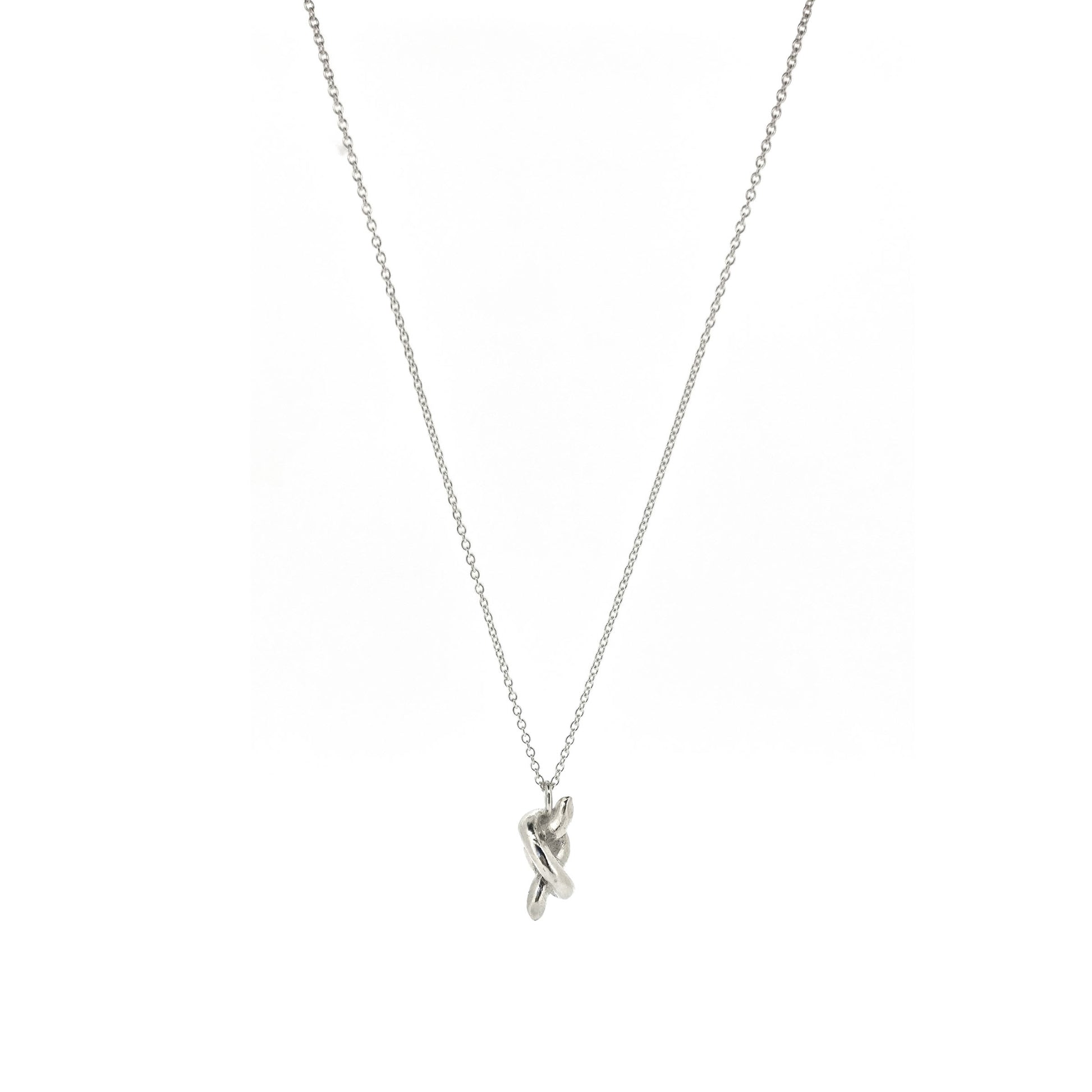 Silver chain with a silver knot pendant.