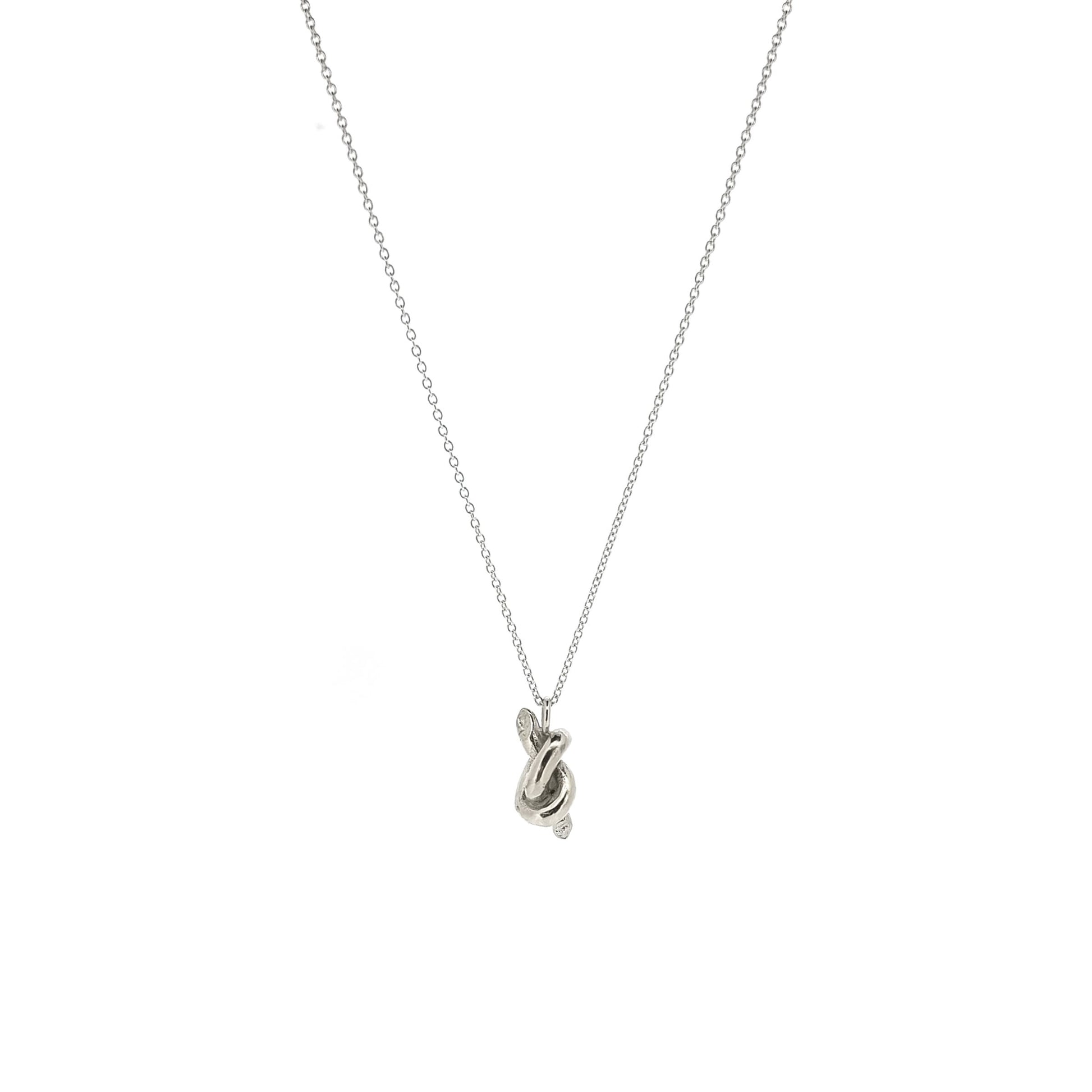 Silver chain with a silver knot pendant.