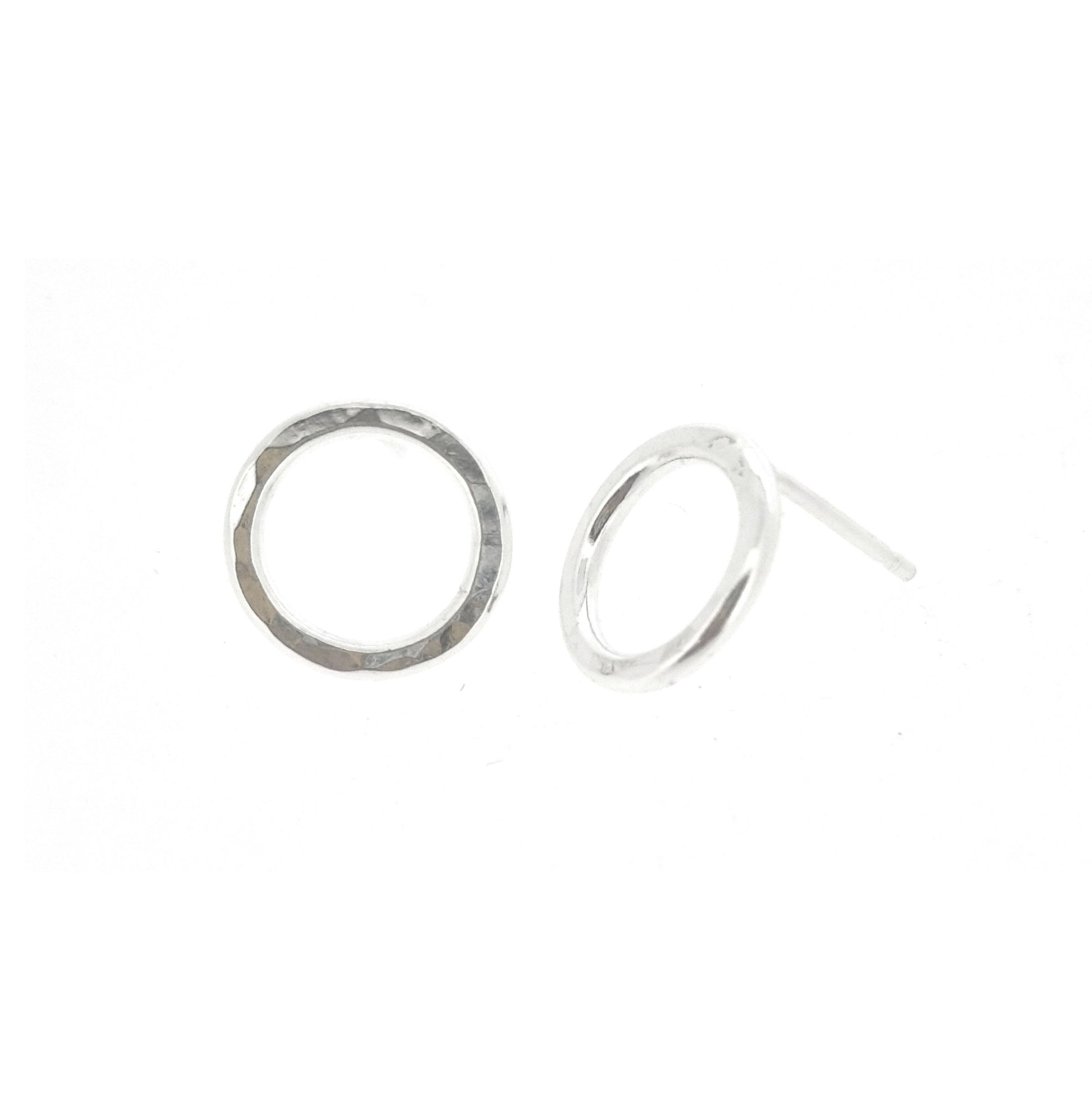Silver open circle stud earrings with hammered texture.