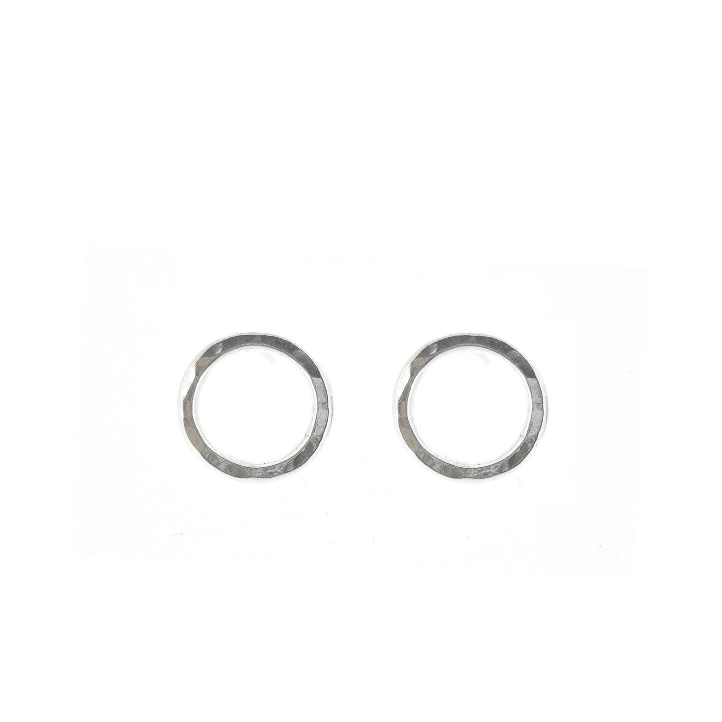 Silver open circle stud earrings with hammered texture.