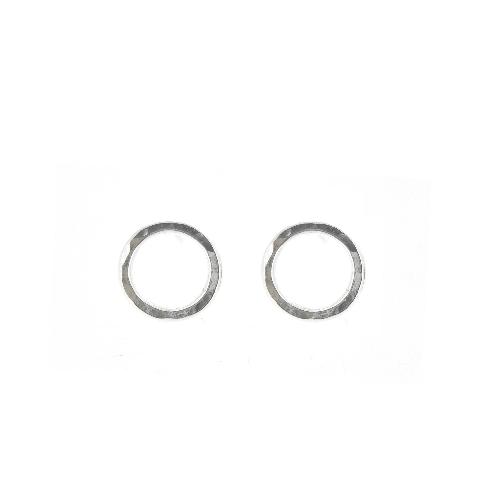 Silver open circle stud earrings with hammered texture.
