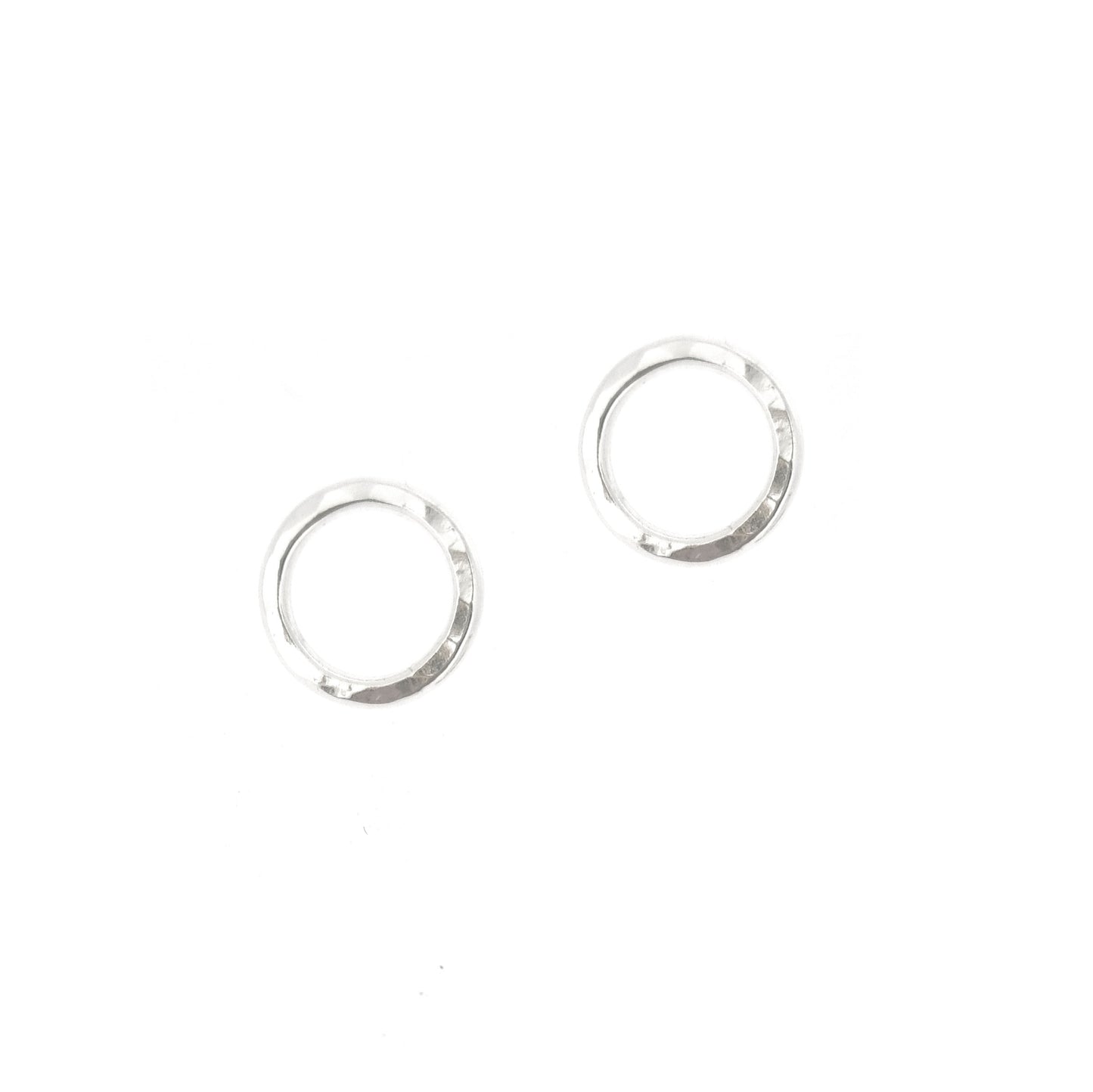 Silver open circle stud earrings with hammered texture.