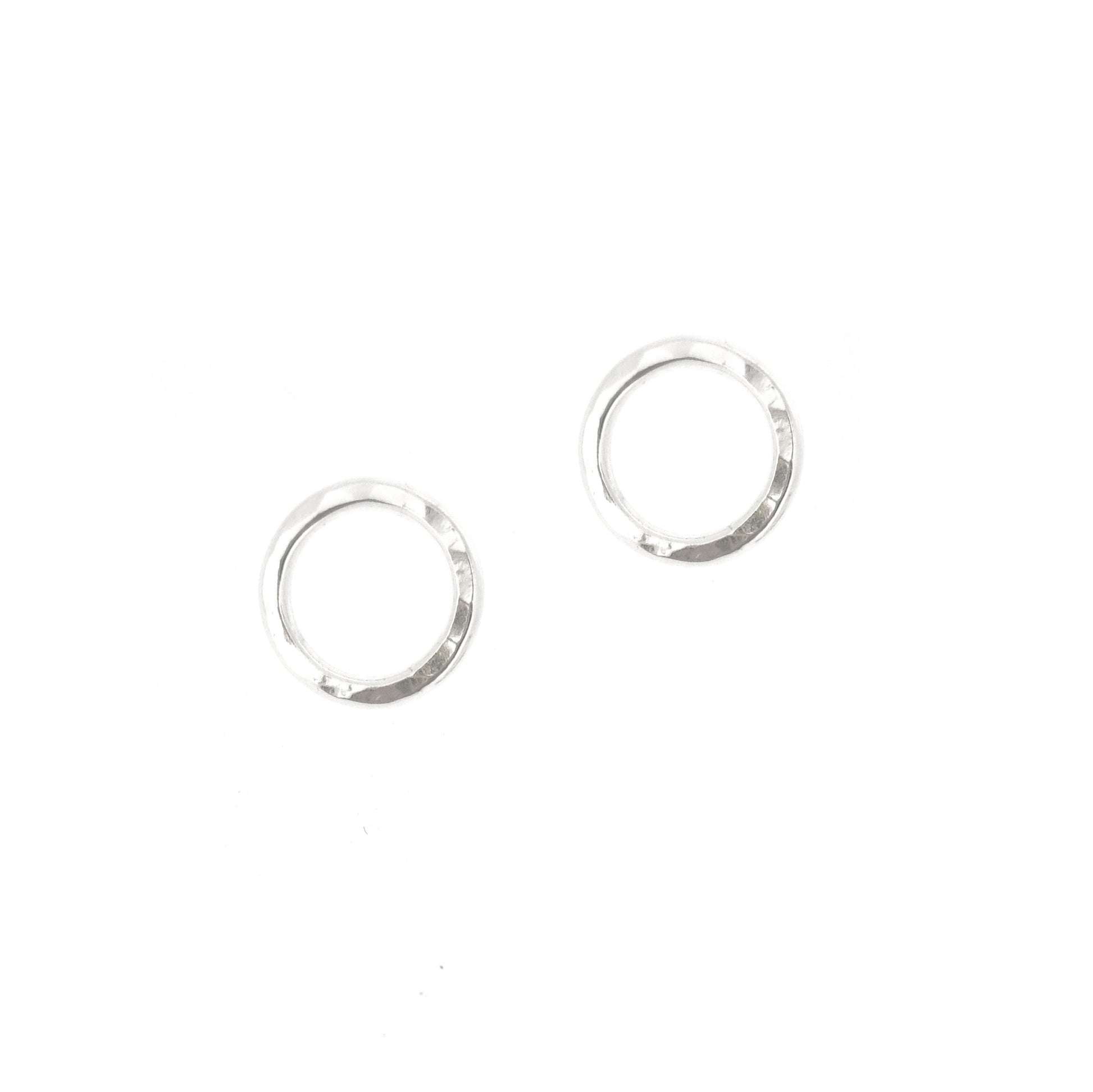 Silver open circle stud earrings with hammered texture.