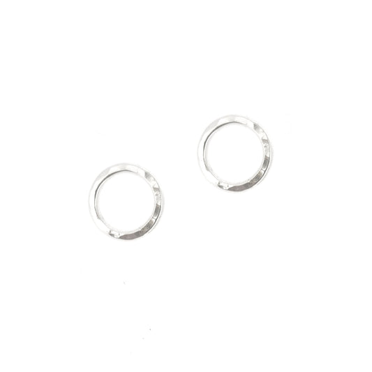 Silver open circle stud earrings with hammered texture.