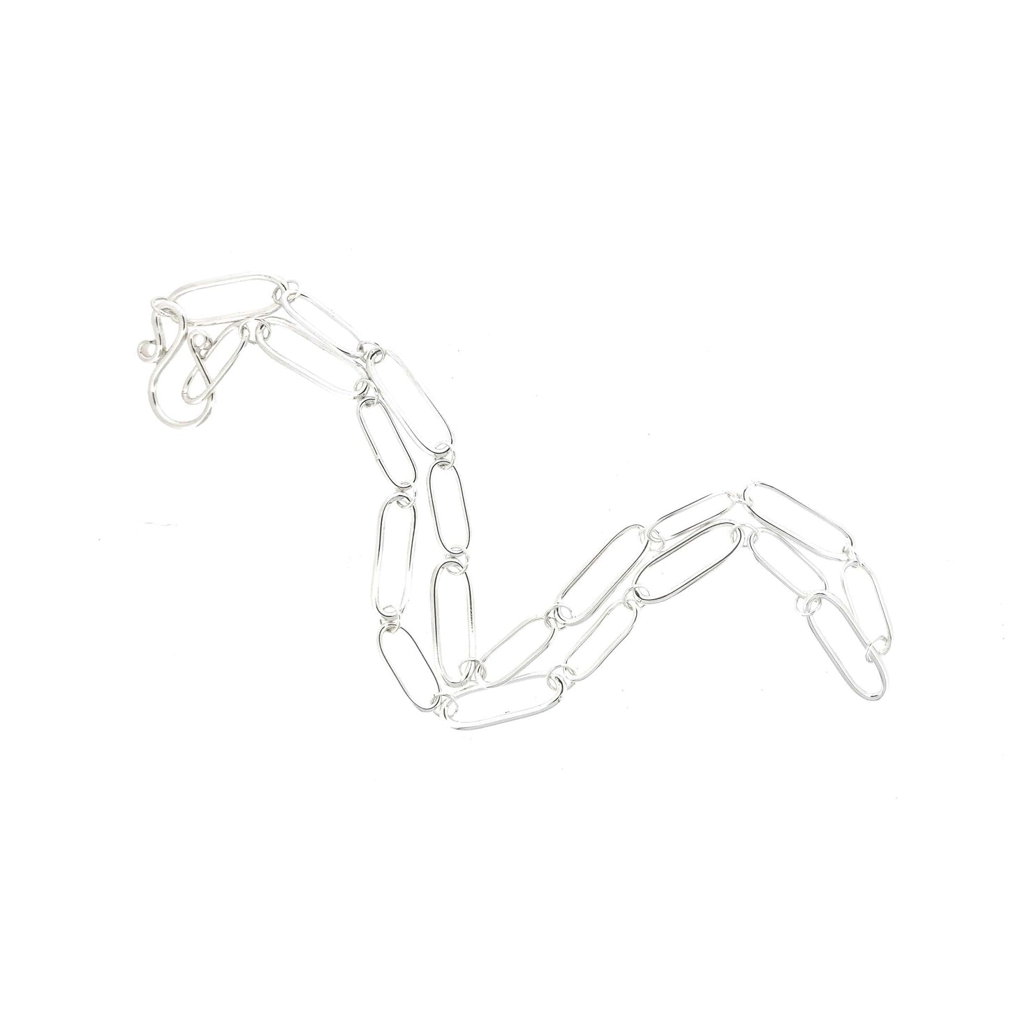 A silver chain necklace with open oblong links of different sizes and an s-clasp.