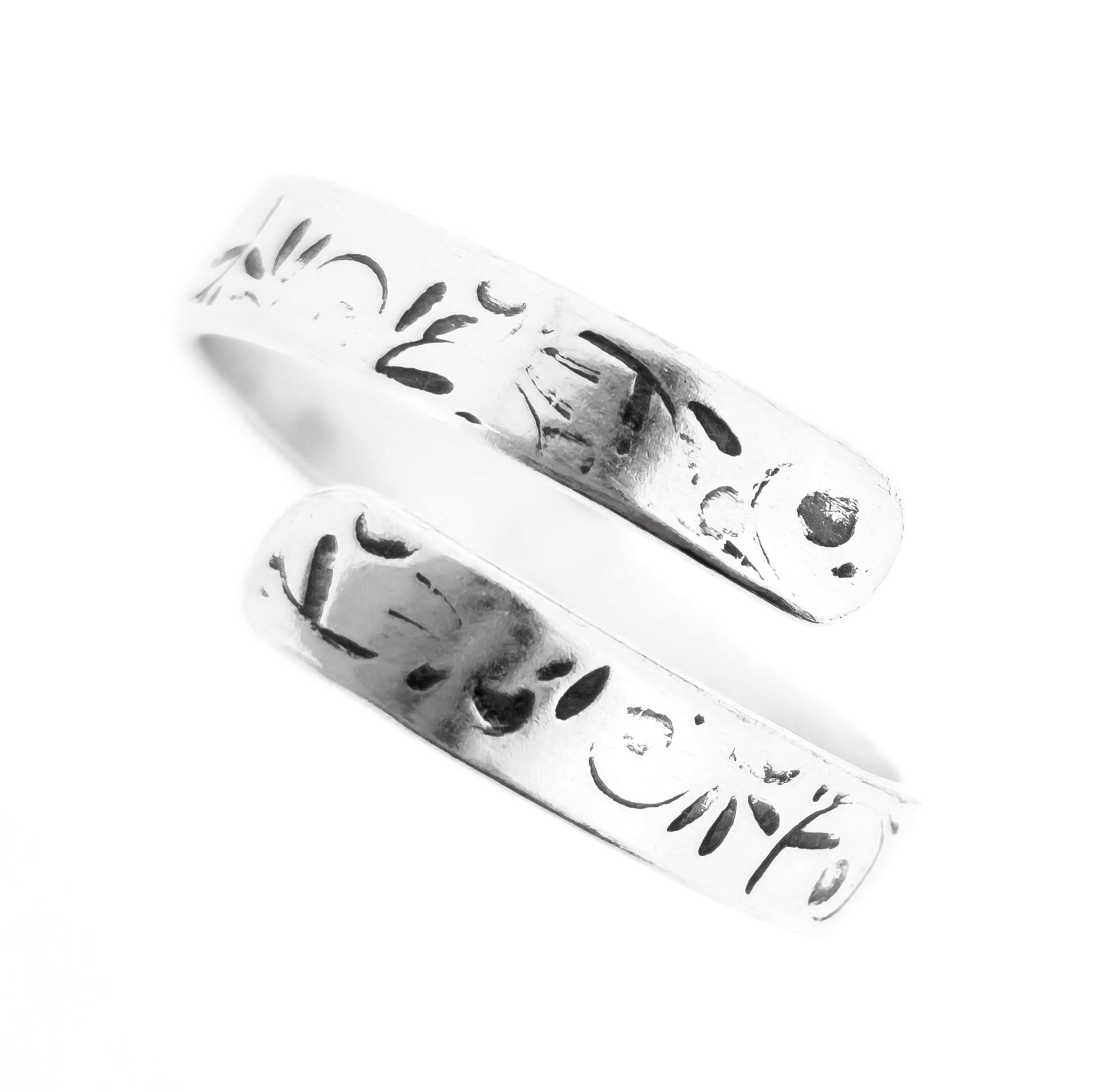 A handmade flat silver band wrap ring with leaf, bud and stalk pattern.