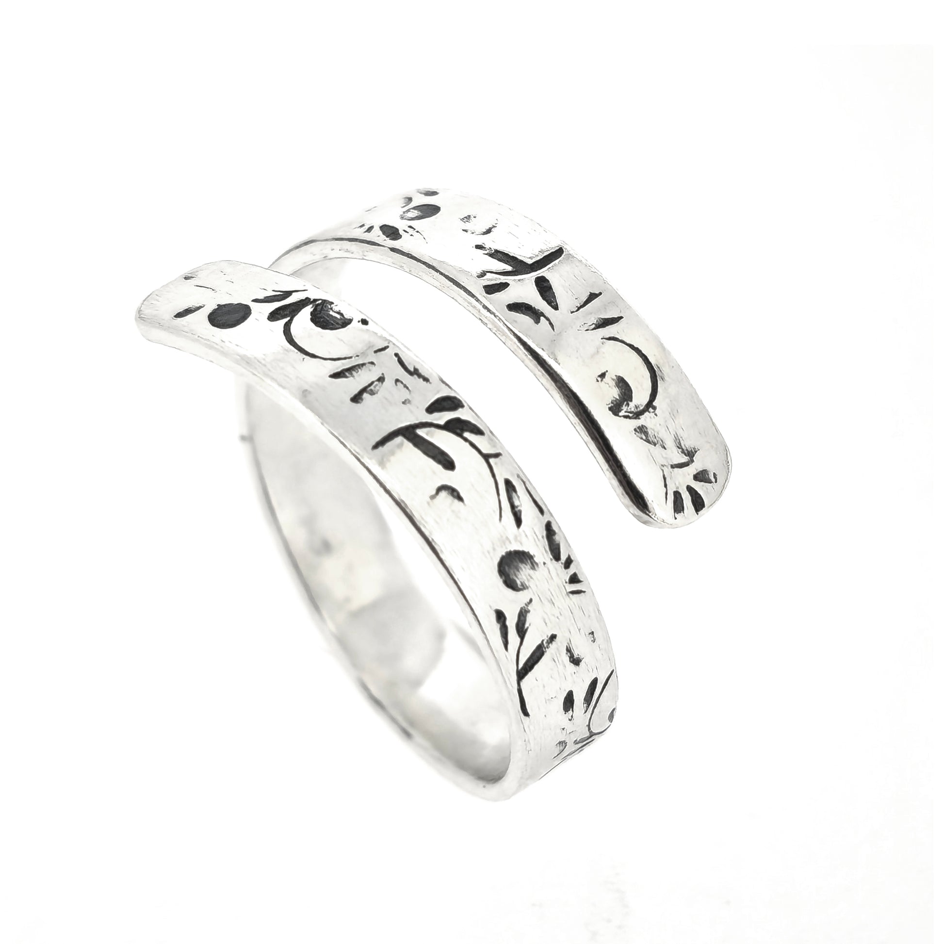 A handmade flat silver band wrap ring with leaf, bud and stalk pattern.