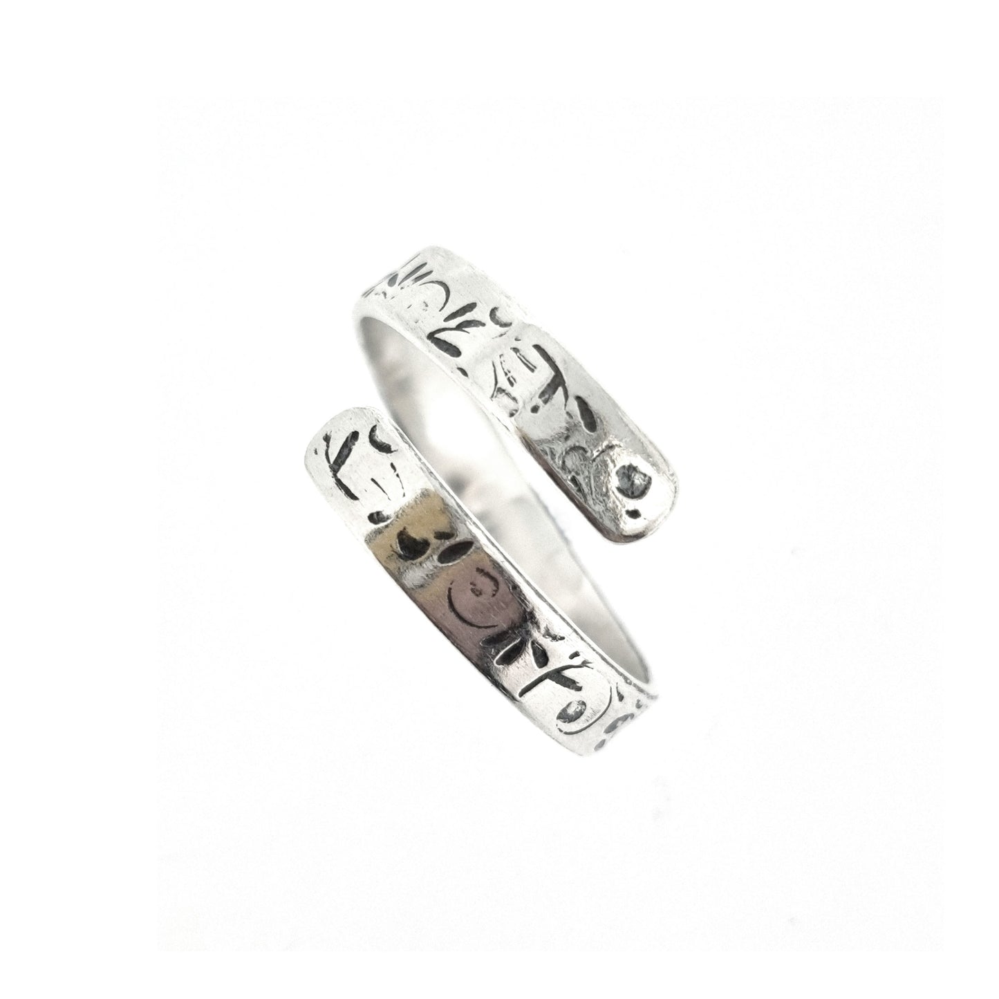 A flat silver wrap ring with leaf, bud and stalk pattern.