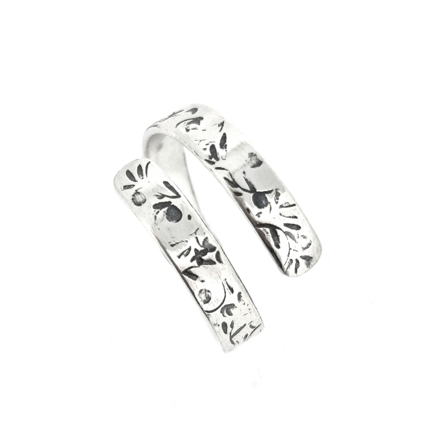 A flat silver wrap ring with leaf, bud and stalk pattern.