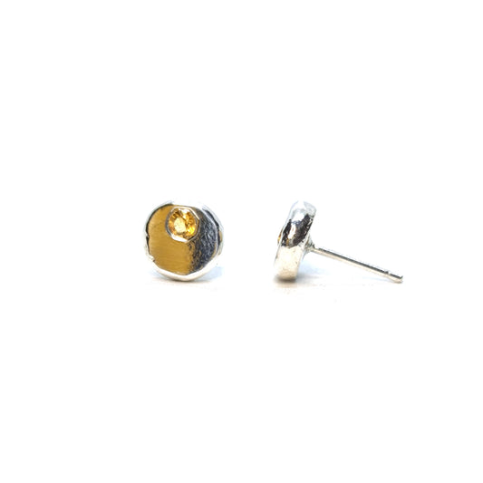 Round silver pebble stud earrings with yellow citrine gemstones flush set off-centre.