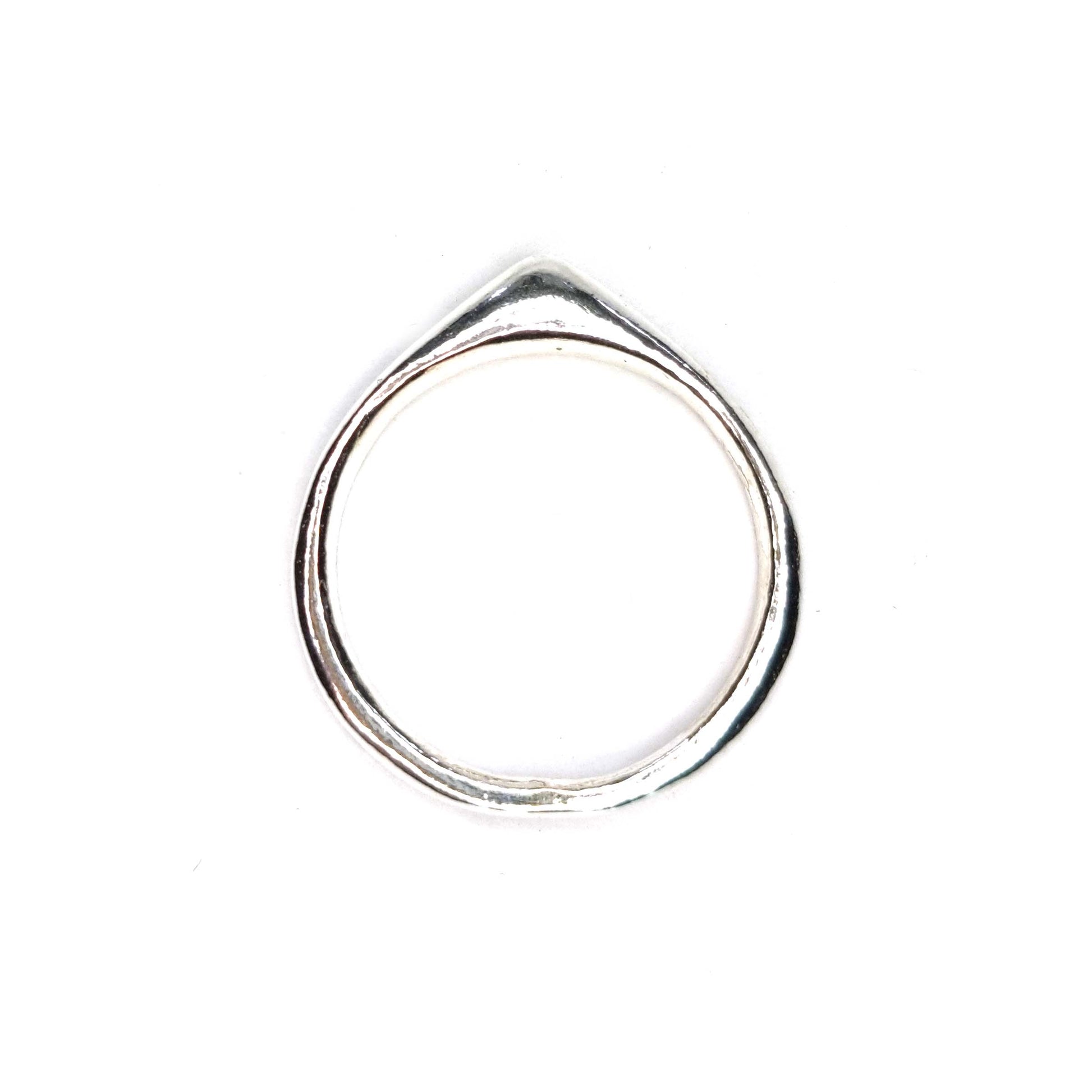 A silver ring which comes to a soft point at the top.
